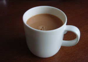 Tea in a tea cup with milk.