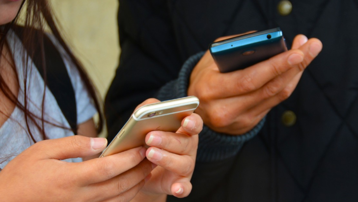 Teenagers using smartphones