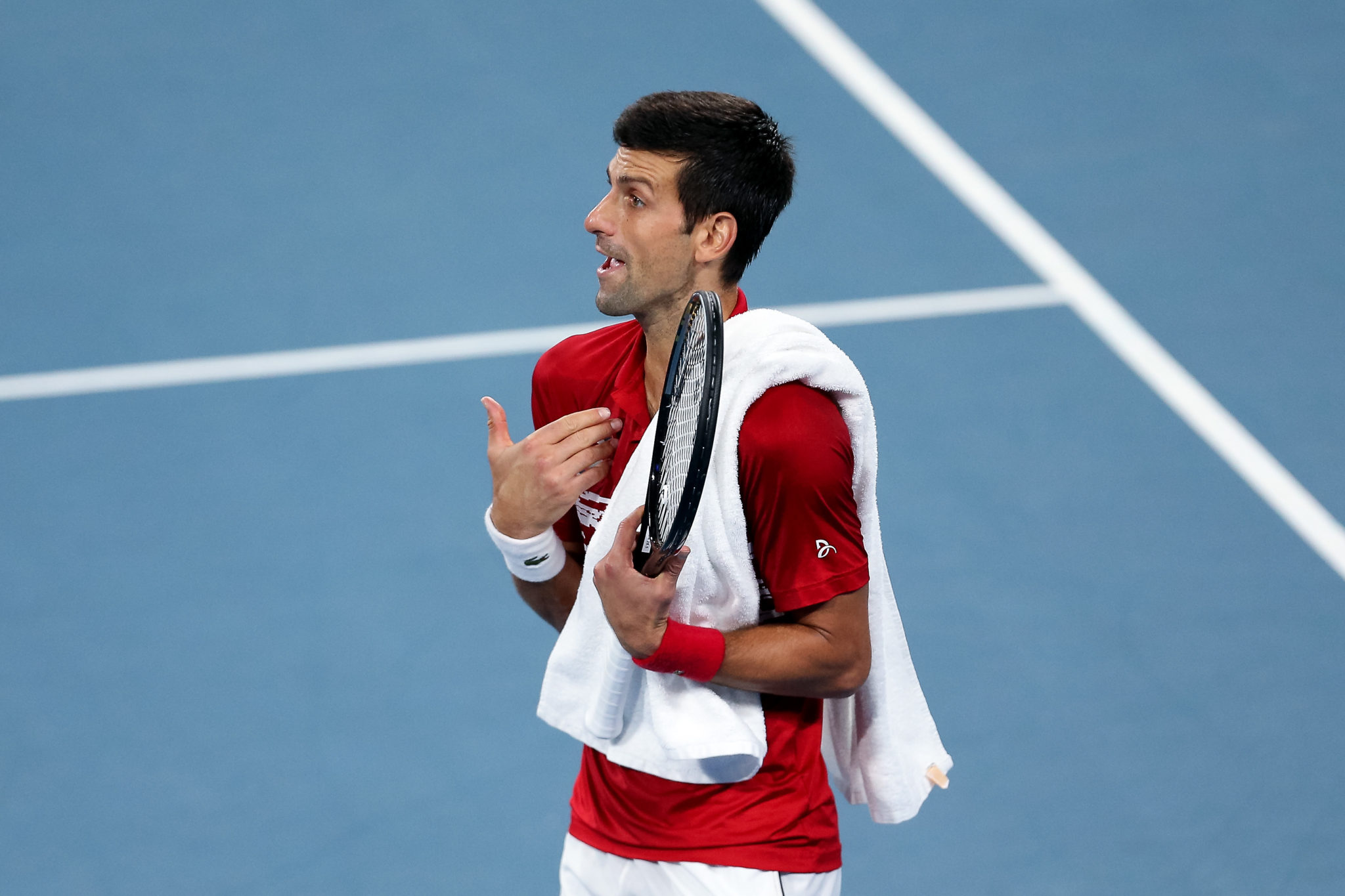 Novak Djokovic speaks with an umpire during the singles final at the 2020 ATP Cup Tennis in Sydney, Australia
