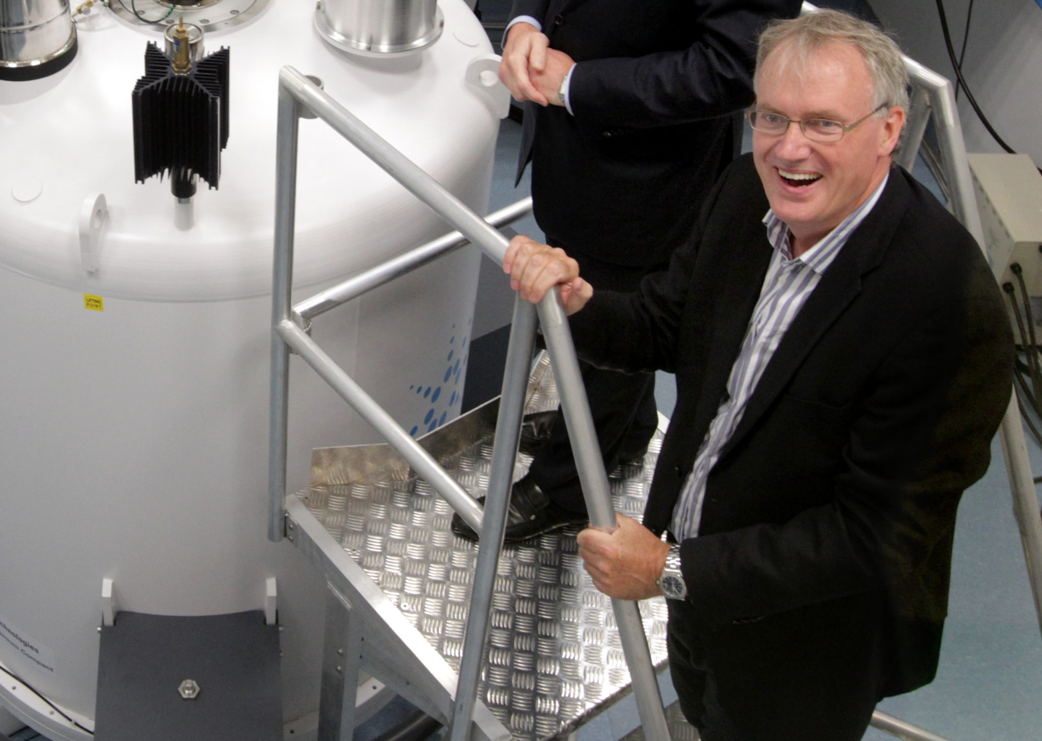 Professor Luke O'Neill pictured next to TBSI's nuclear magnetic resonance instrument COVID-19 resistance