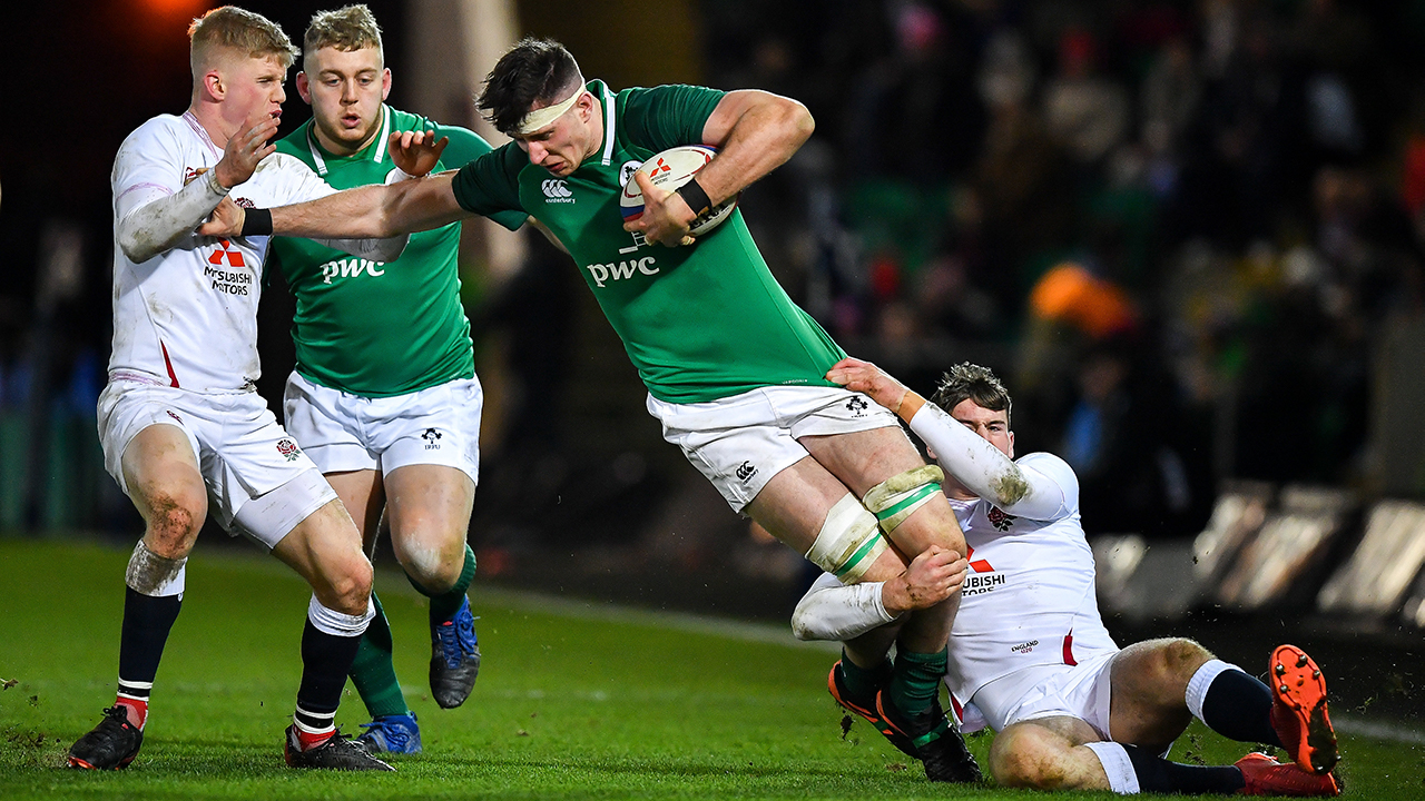 Thomas Ahern of Ireland is tackled by George Barton, left, and Tom Roebuck during the Six Nations U20 Rugby Championship match between England and Ireland at Franklin’s Gardens in Northampton, England