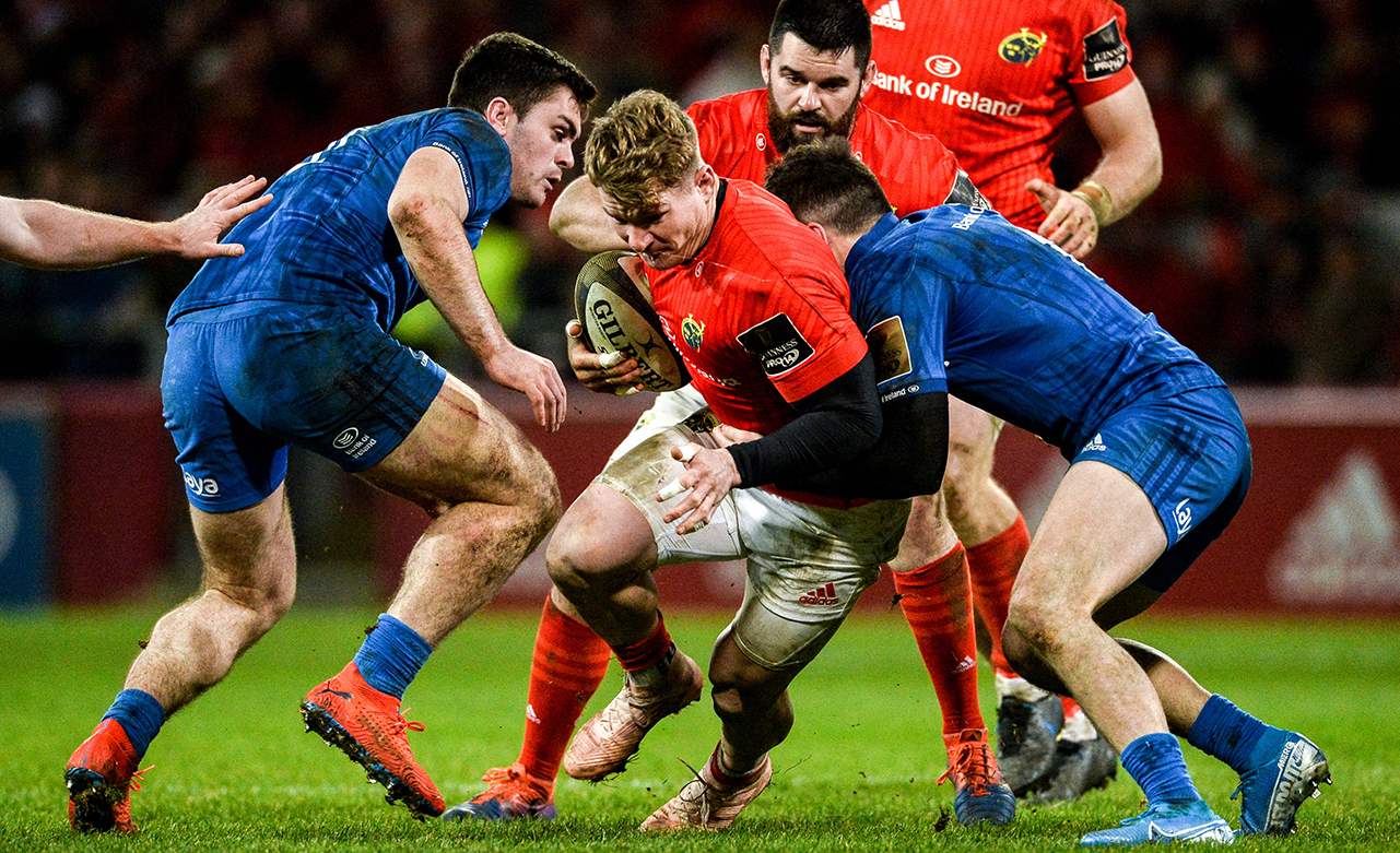 Chris Cloete of Munster is tackled by Conor O'Brien and Jimmy O'Brien of Leinster during the Guinness PRO14 Round 9 match between Munster and Leinster