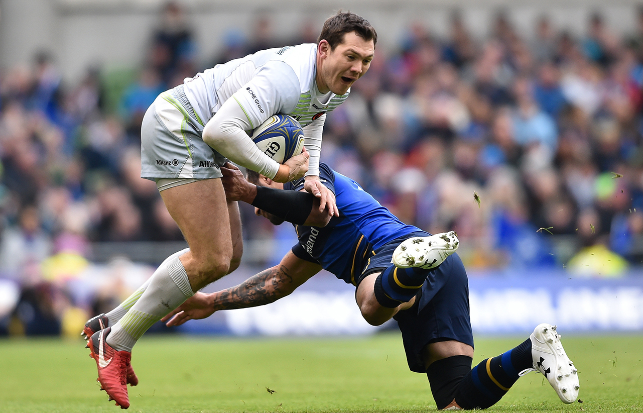 Alex Goode of Saracens is tackled by Isa Nacewa of Leinster during the European Rugby Champions Cup quarter-final match between Leinster and Saracens at the Aviva Stadium