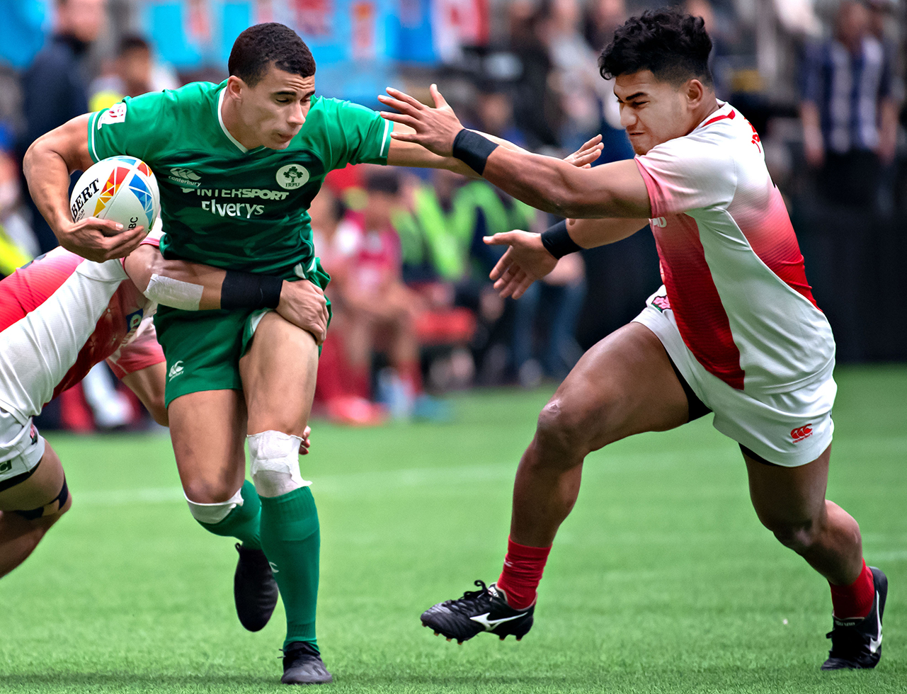 Jordan Conroy (L) of Ireland and Timo Fiti Sufia of Japan compete during their 13th place semifinal match of the HSBC World Rugby Seven Series at BC Place in Vancouver