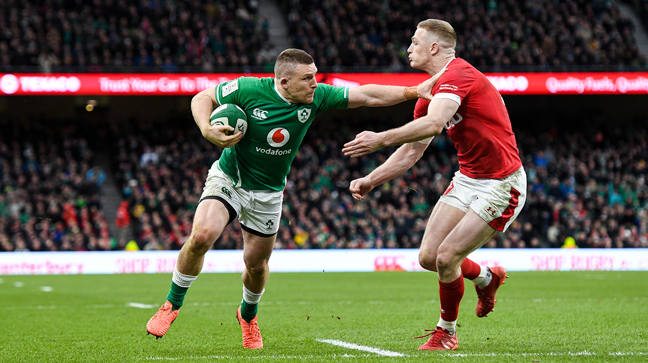 Andrew Conway of Ireland on his way to scoring his side's fourth try despite the tackle of Johnny McNicholl of Wales during the Guinness Six Nations Rugby Championship match between Ireland and Wales at the Aviva Stadium in Dublin.