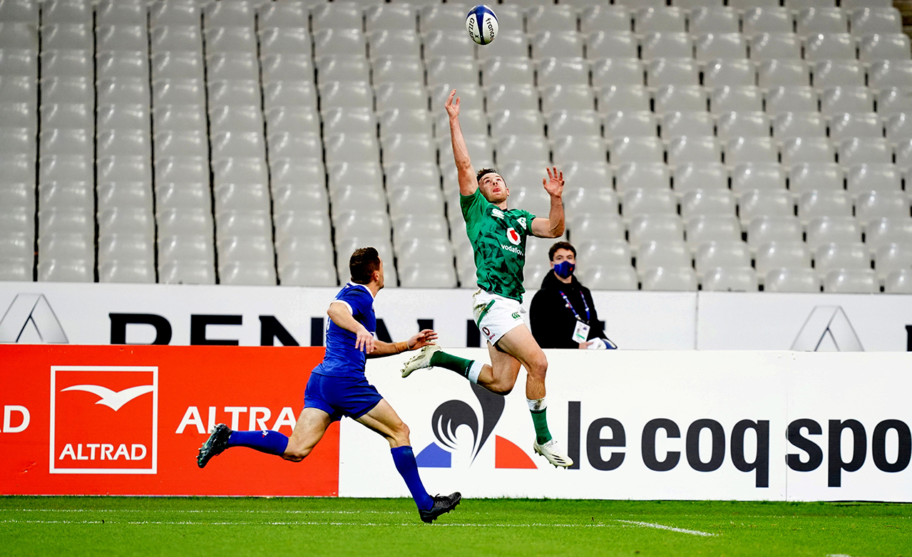 Hugo Keenan of Ireland attempts to collect a kick from team-mate Jonathan Sexton next to the try line as Anthony Bouthier of France closes on during the Guinness Six Nations Rugby Championship match between France and Ireland at Stade de France in Paris, France.