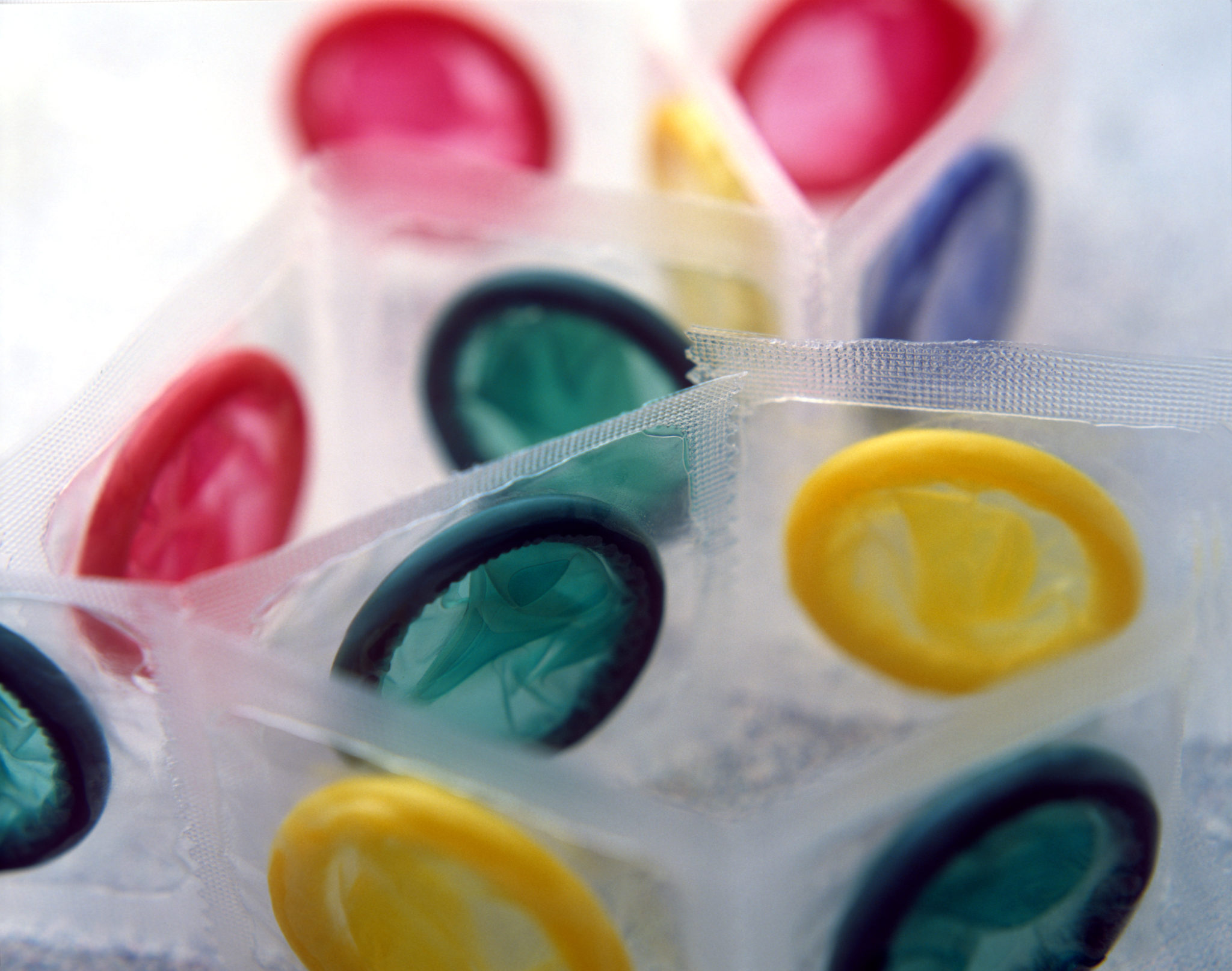 Multi-coloured condoms in packets