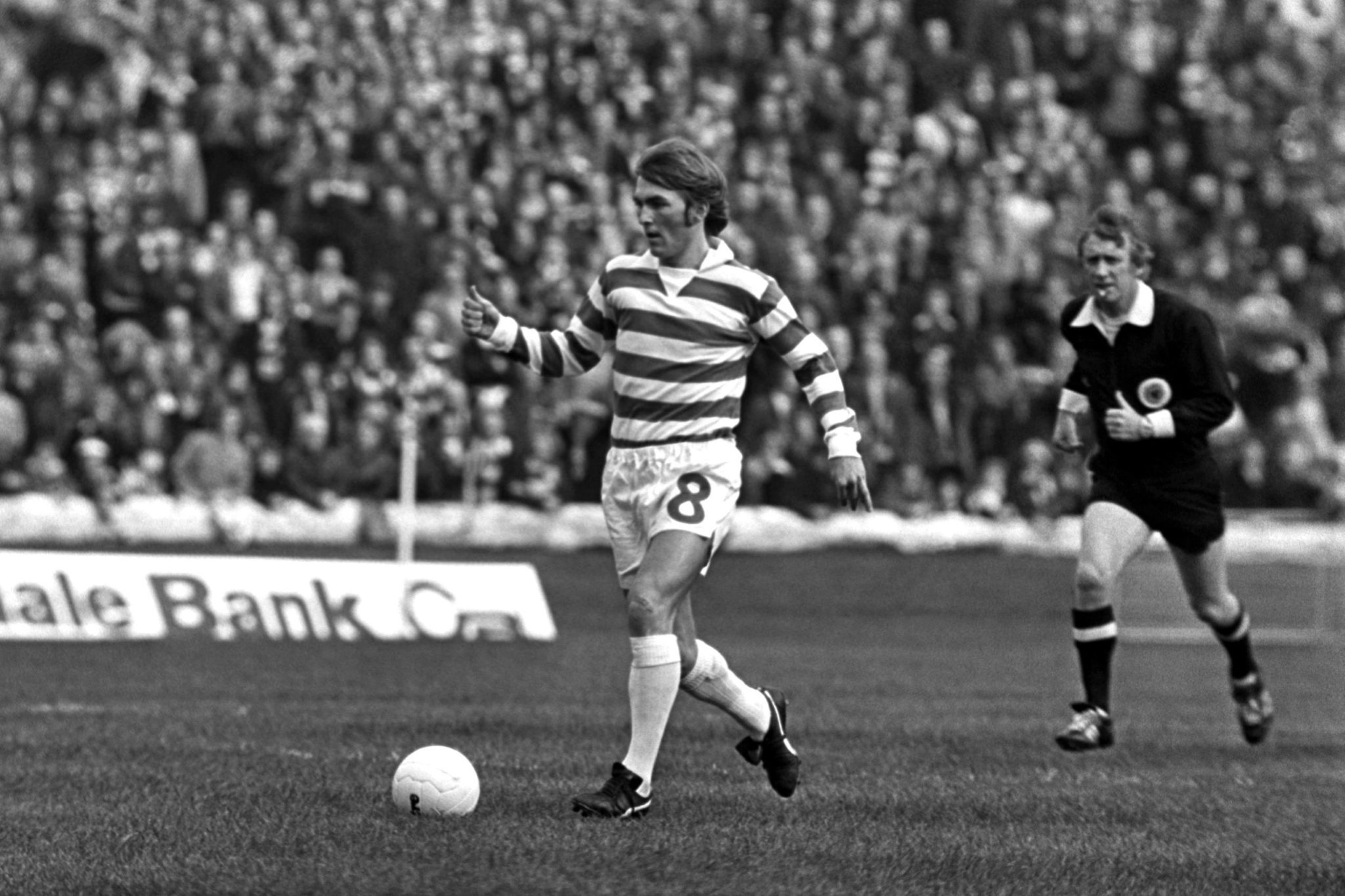 Kenny Dalglish dribbles the ball for Celtic