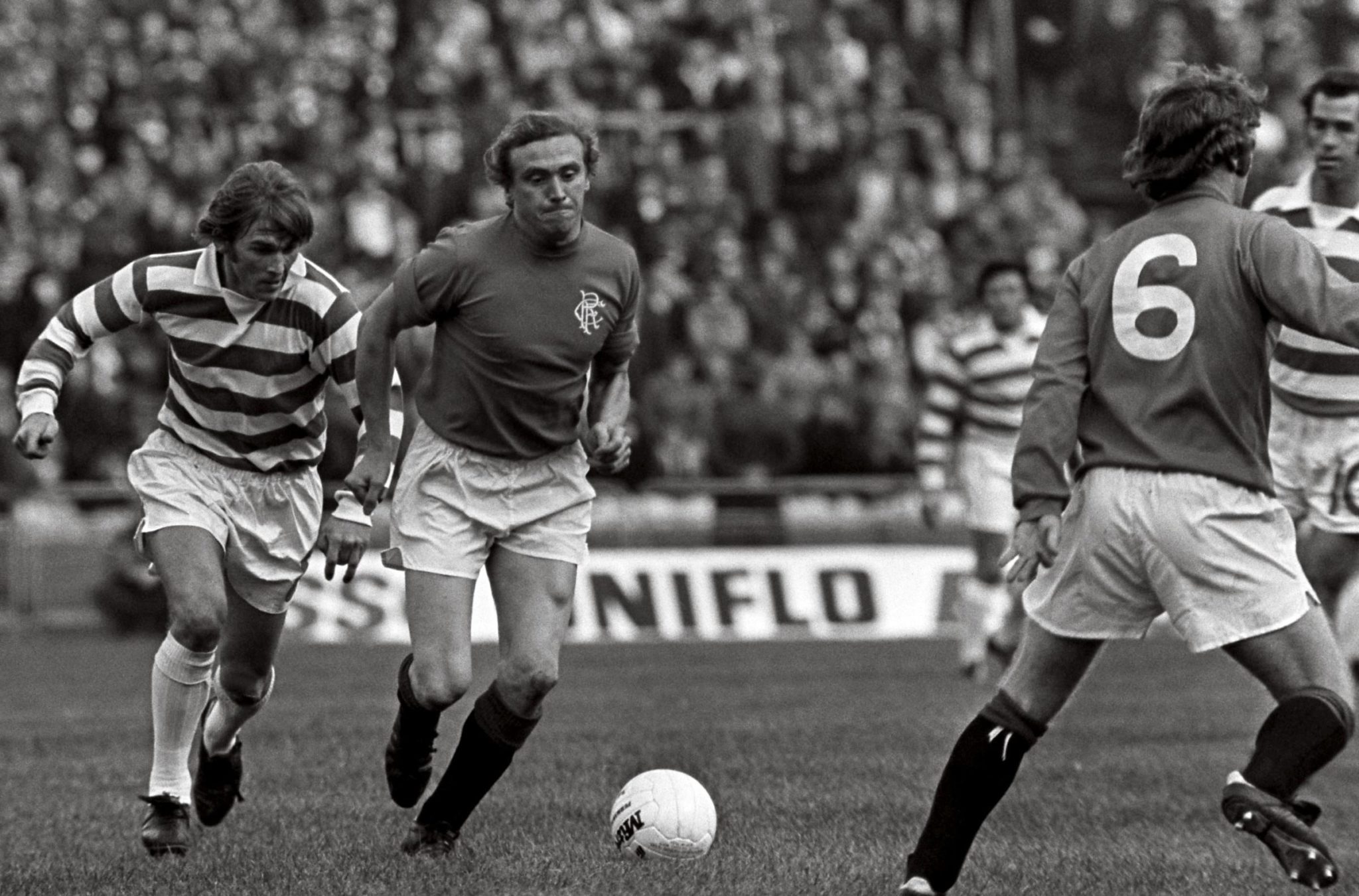 Kenny Dalglish races away from a defender during a game between Celtic and Rangers