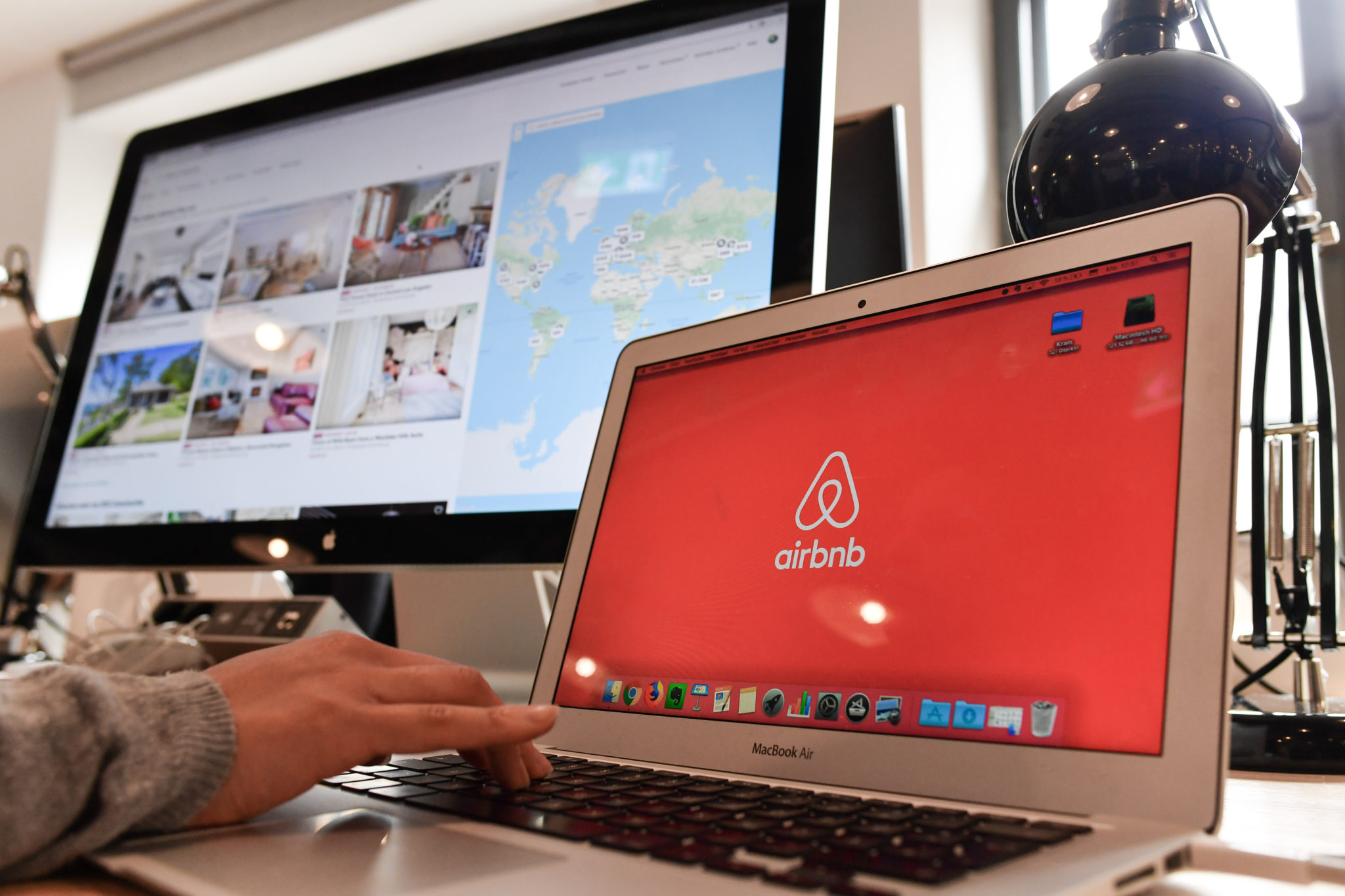 Airbnb's logo can be seen on different screens in Berlin, Germany in 2018