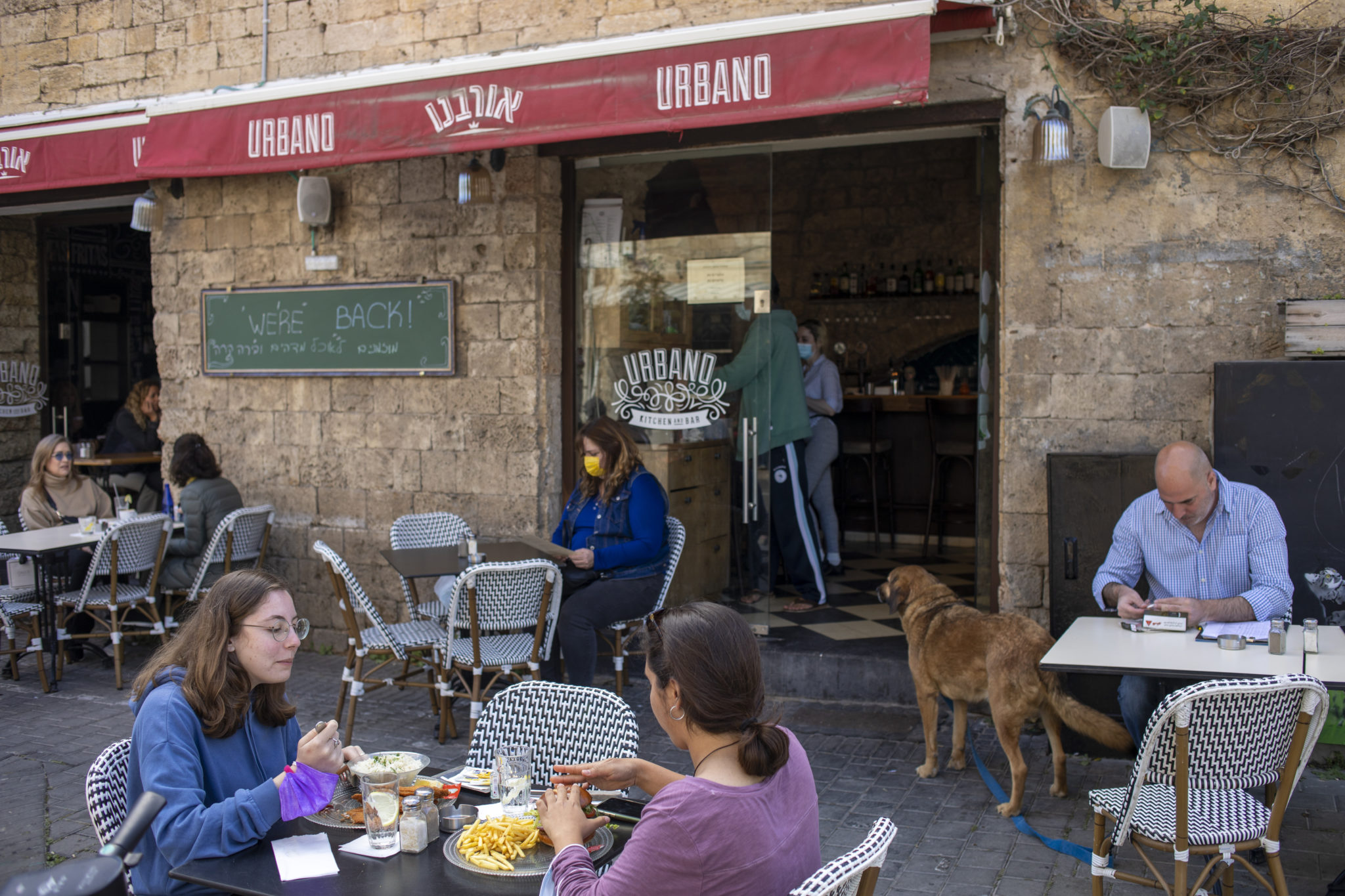People eat in a restaurant as restrictions are eased following months of government-imposed shutdowns, in Tel Aviv, Israel