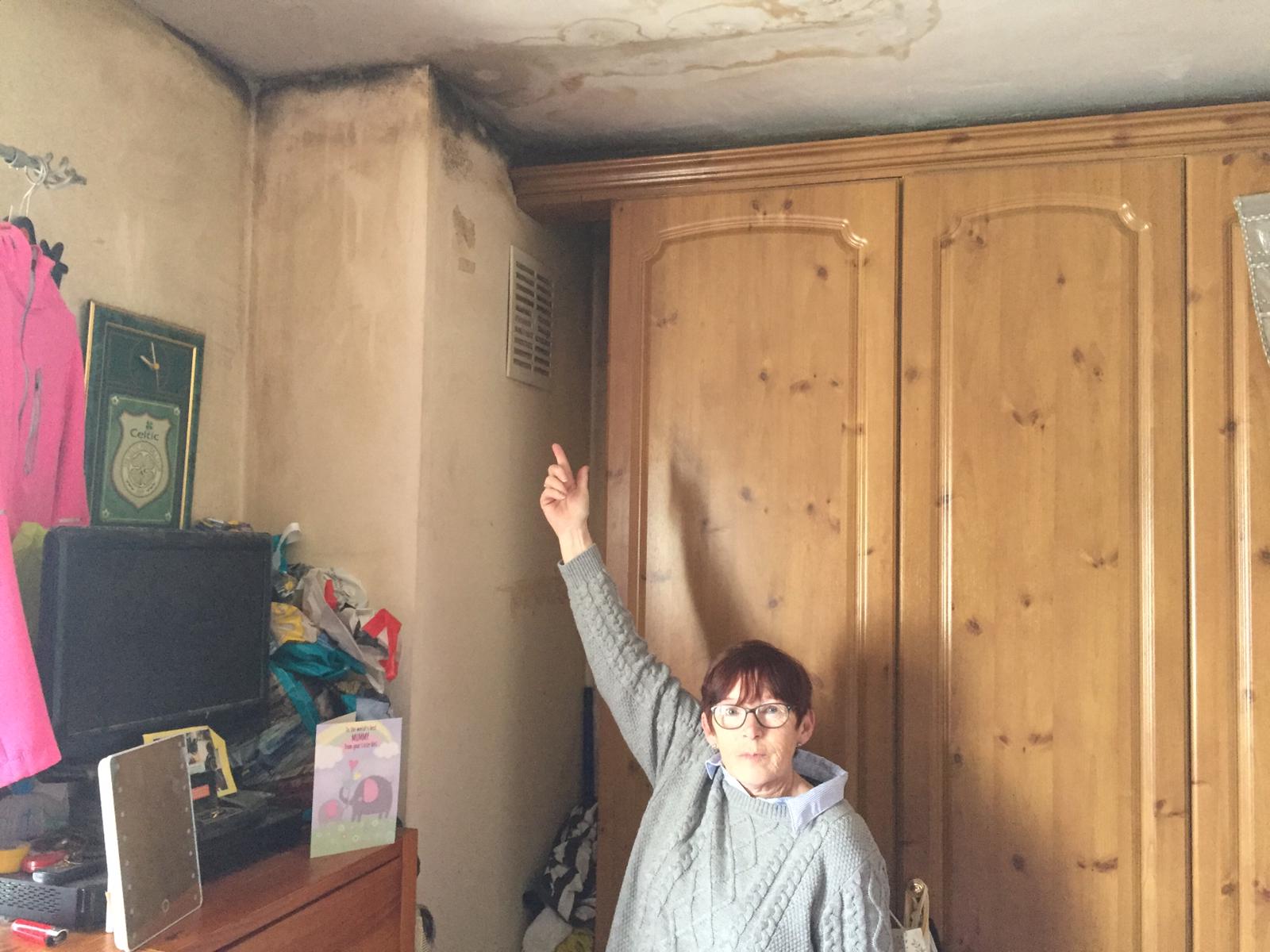 Geraldine Holland showing damp in her Pearse House flat
