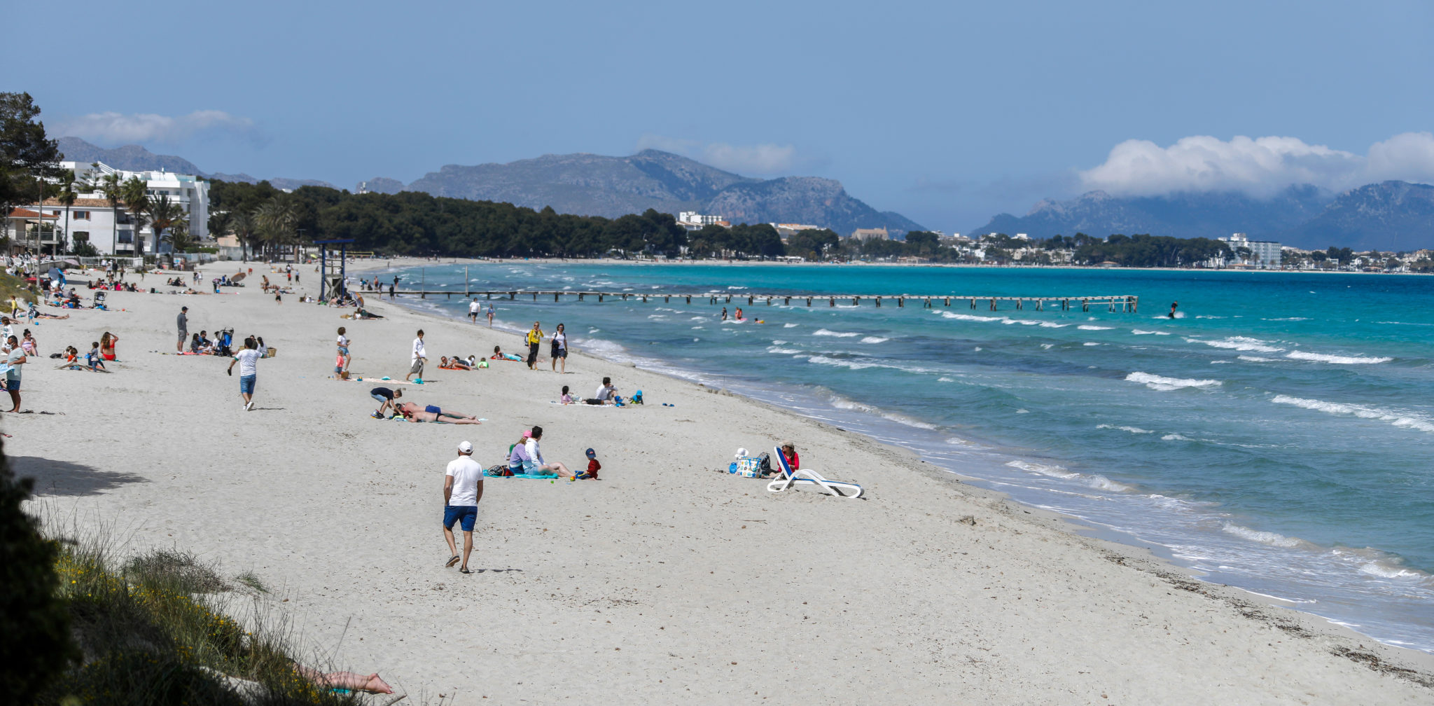 People on holiday on the beach in Muro, Majorca