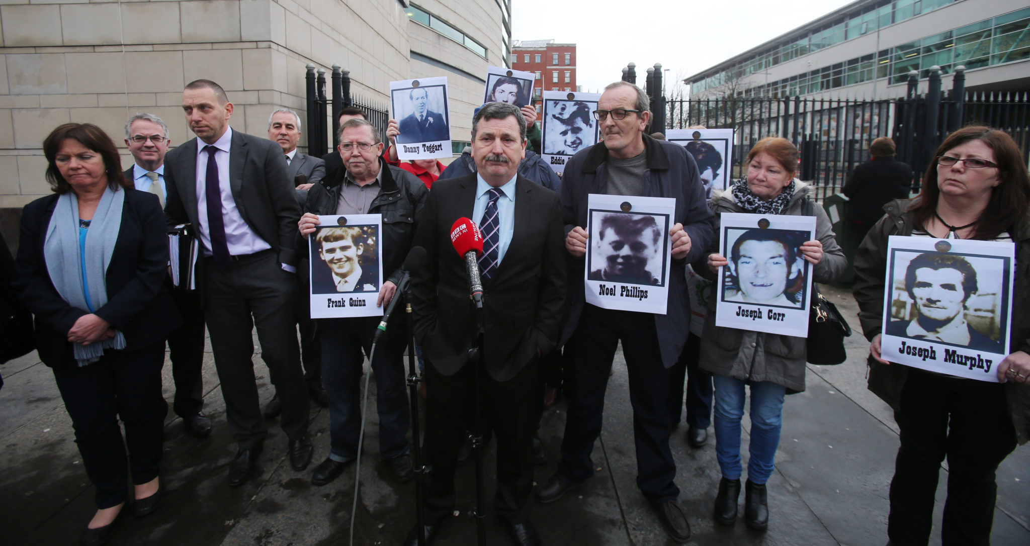 John Teggart (centre) stands with fellow campaigners outside Laganside Courts in Belfast in January 2016.