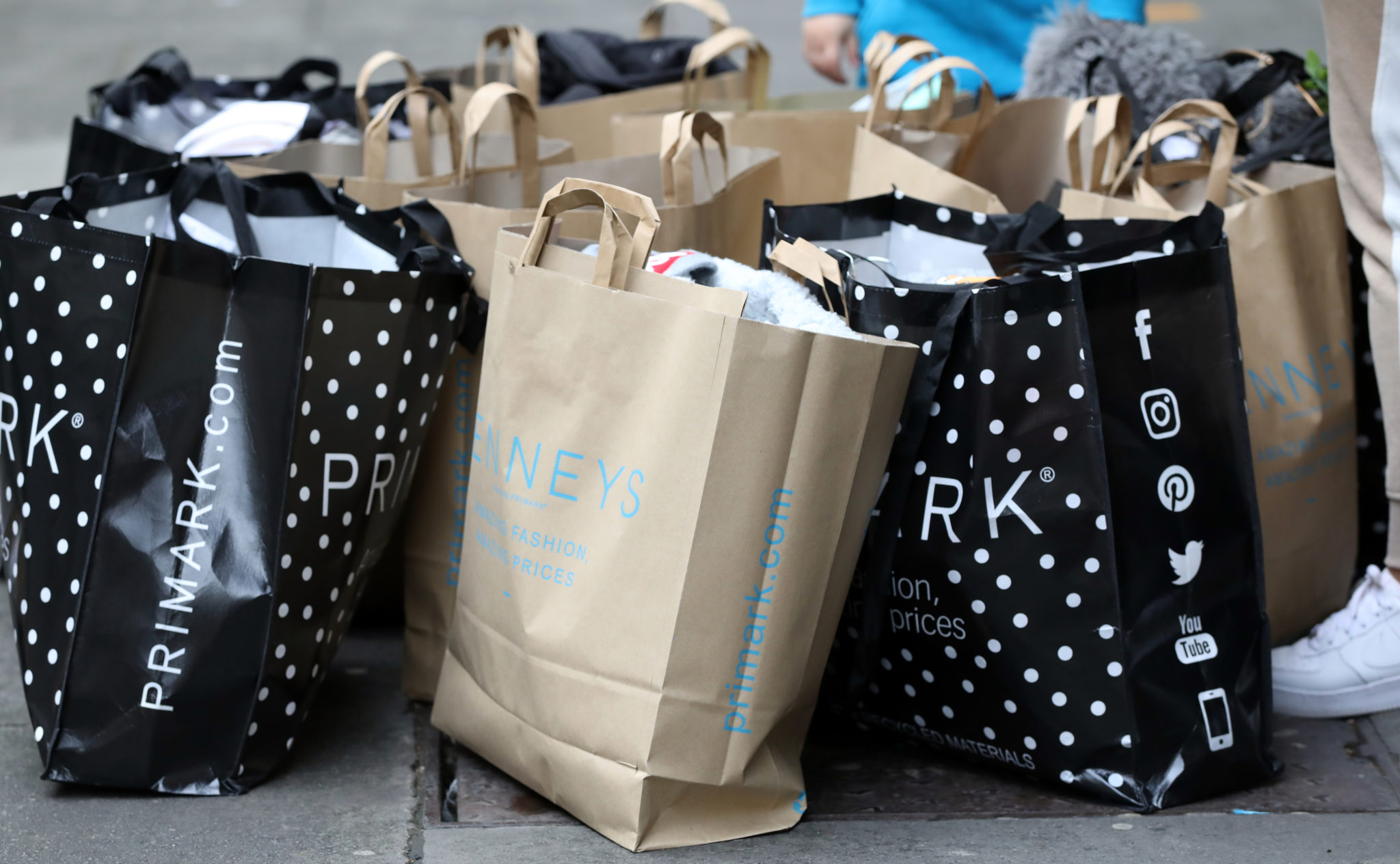 People with shopping bags outside a Penneys store on O'Connell Street in Dublin, on the first day of shops re-opening