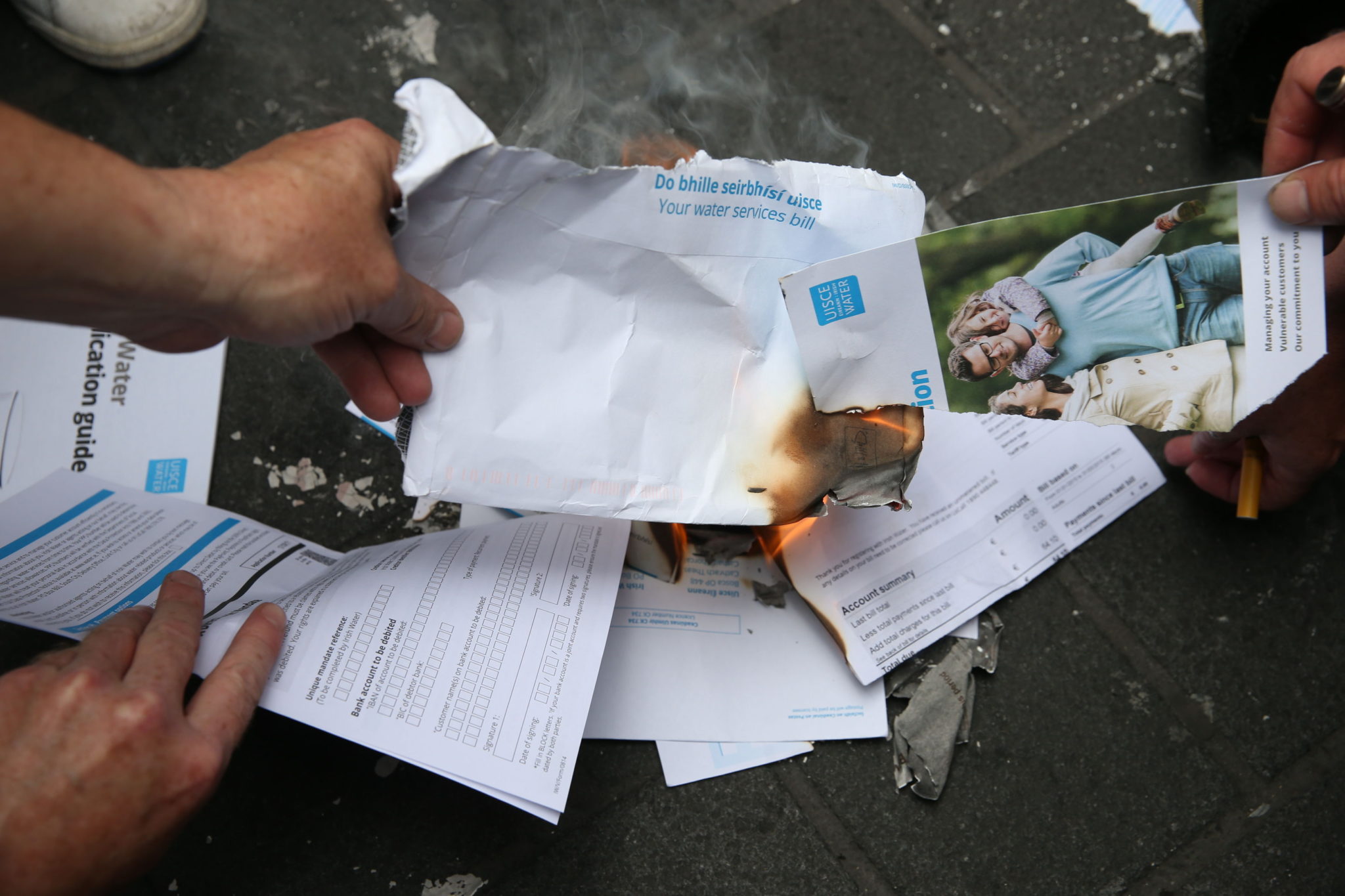 Protesters burn water bills on O'Connell Street in Dublin, during a demonstration against water charges in January 2015