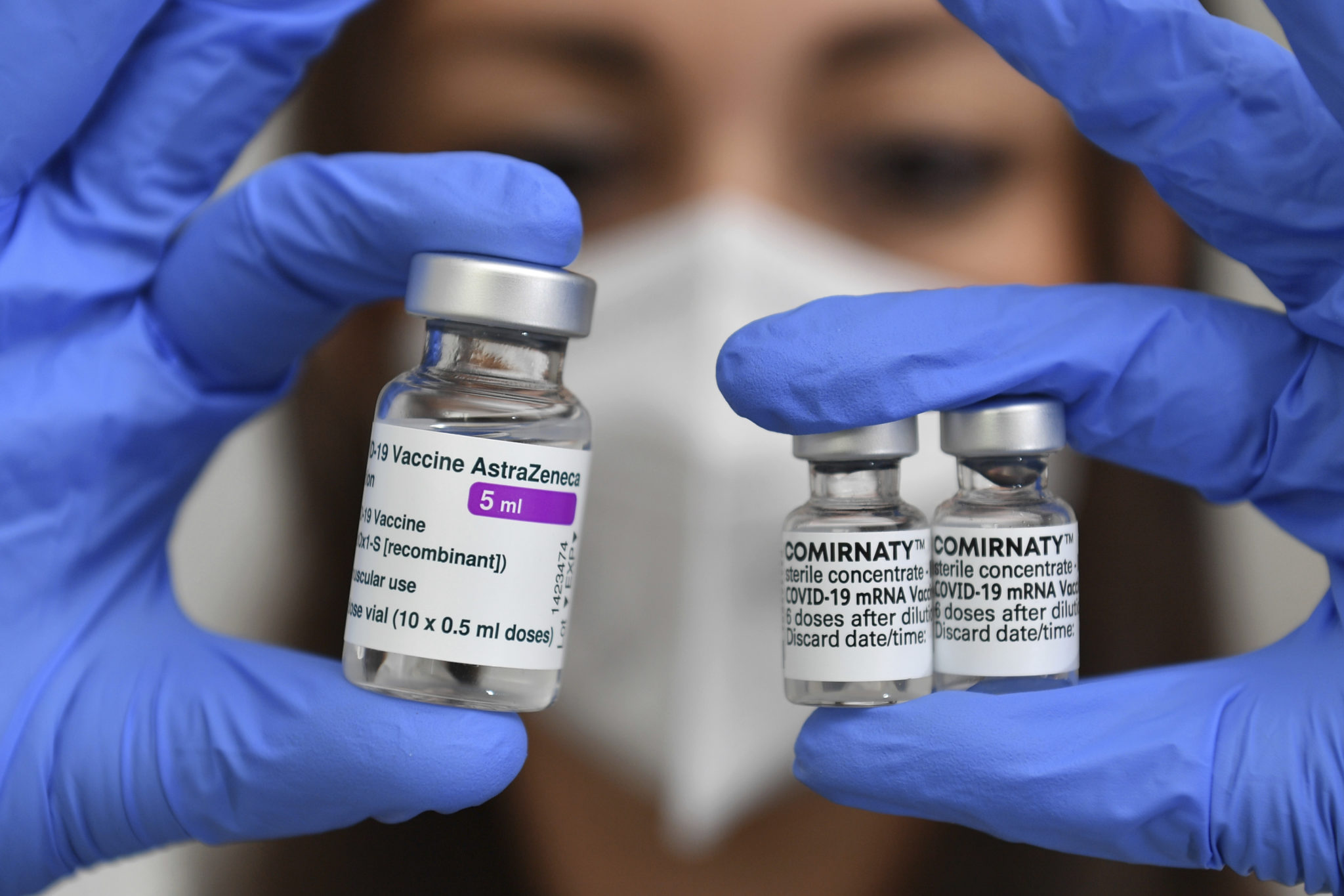 A woman holding COVID-19 vaccine vials