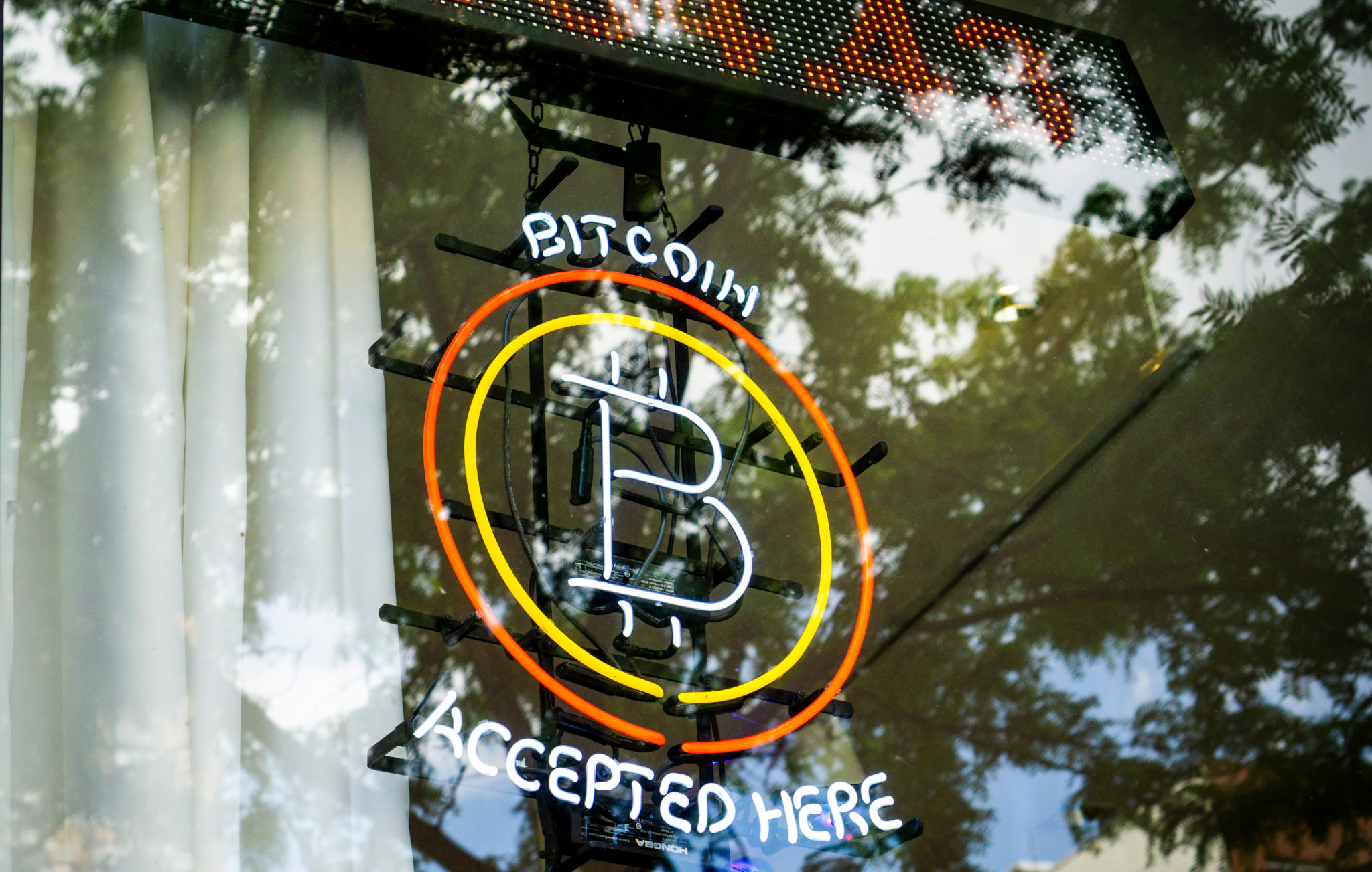 Bitcoin accepted here is displayed in the window of a store in the East Village in New York, 15-05-2021
