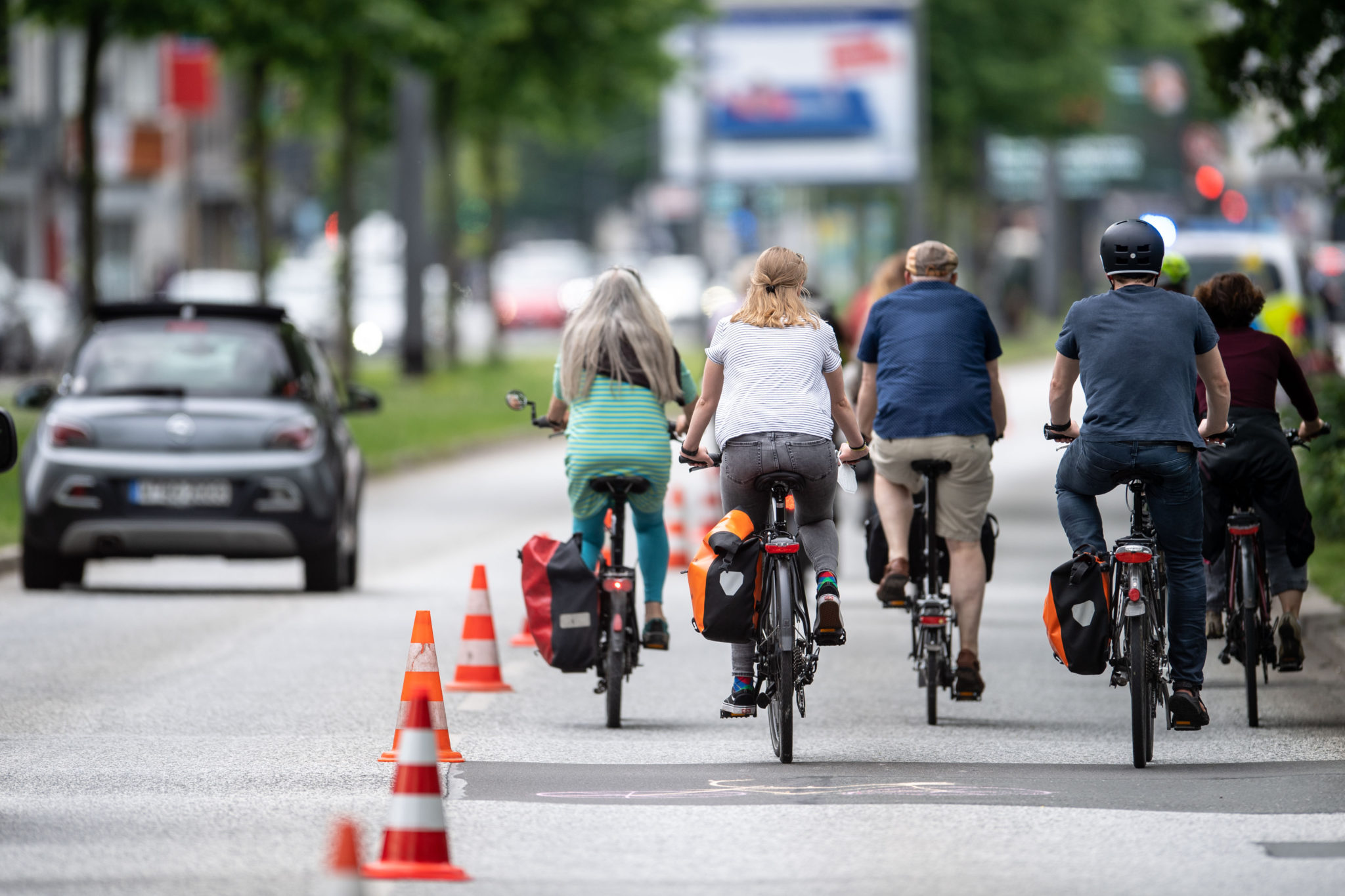 Cyclists ride on a 'pop-up cycle path' in Germany June 2021