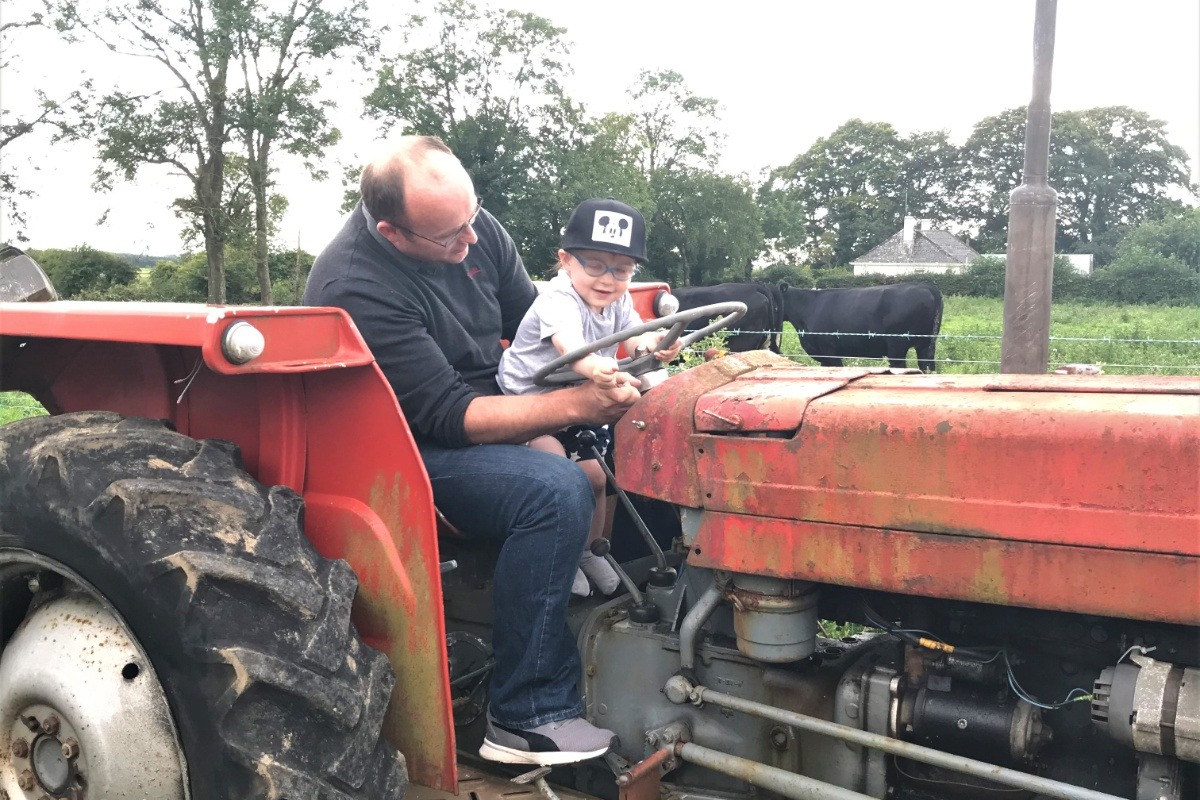Aidan Kenny with his da Seán on a tractor