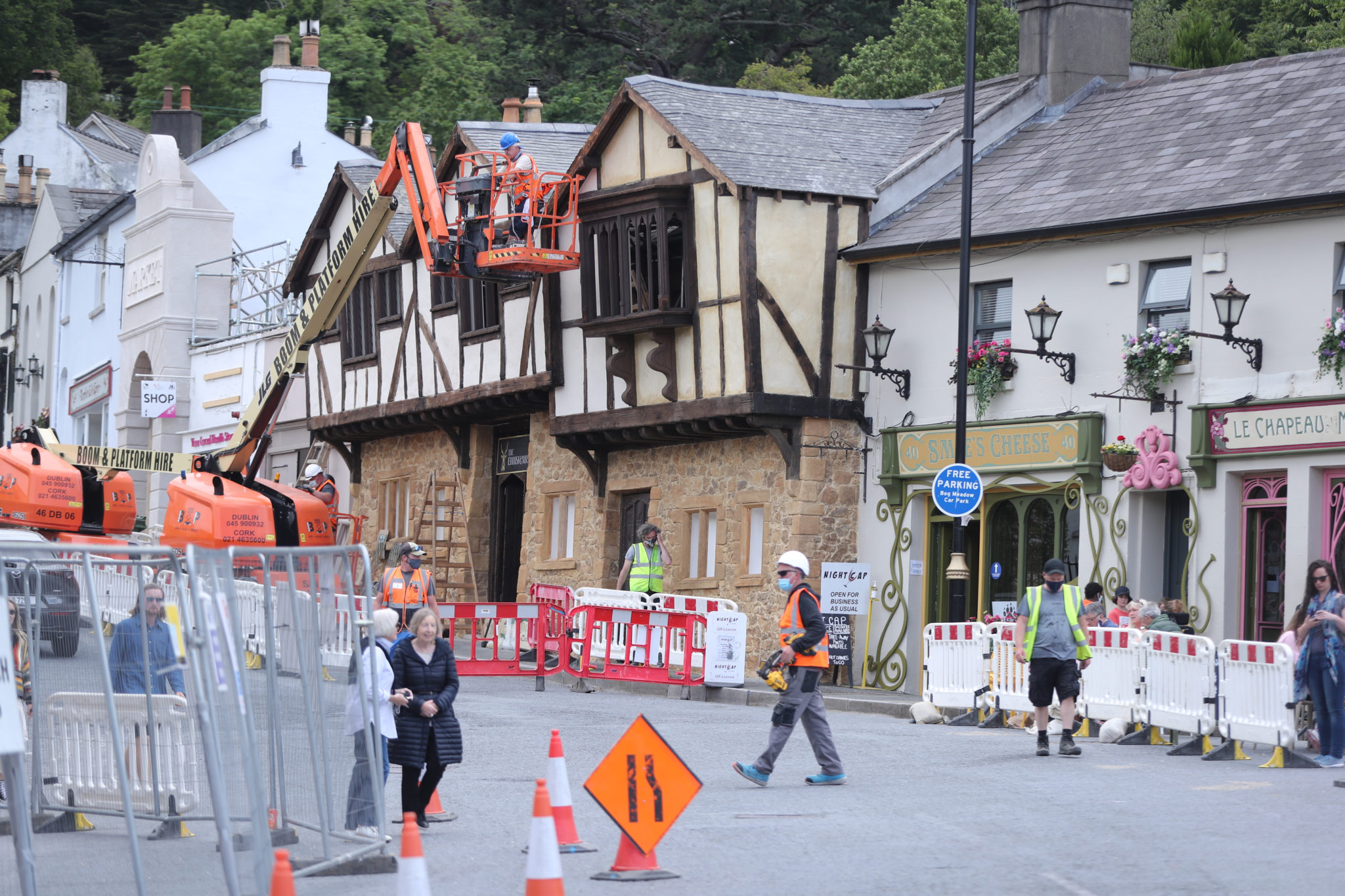 Local people carry on with daily life whilst workers transform Enniskerry village in County Wicklow, Ireland, into part of a Disney film set