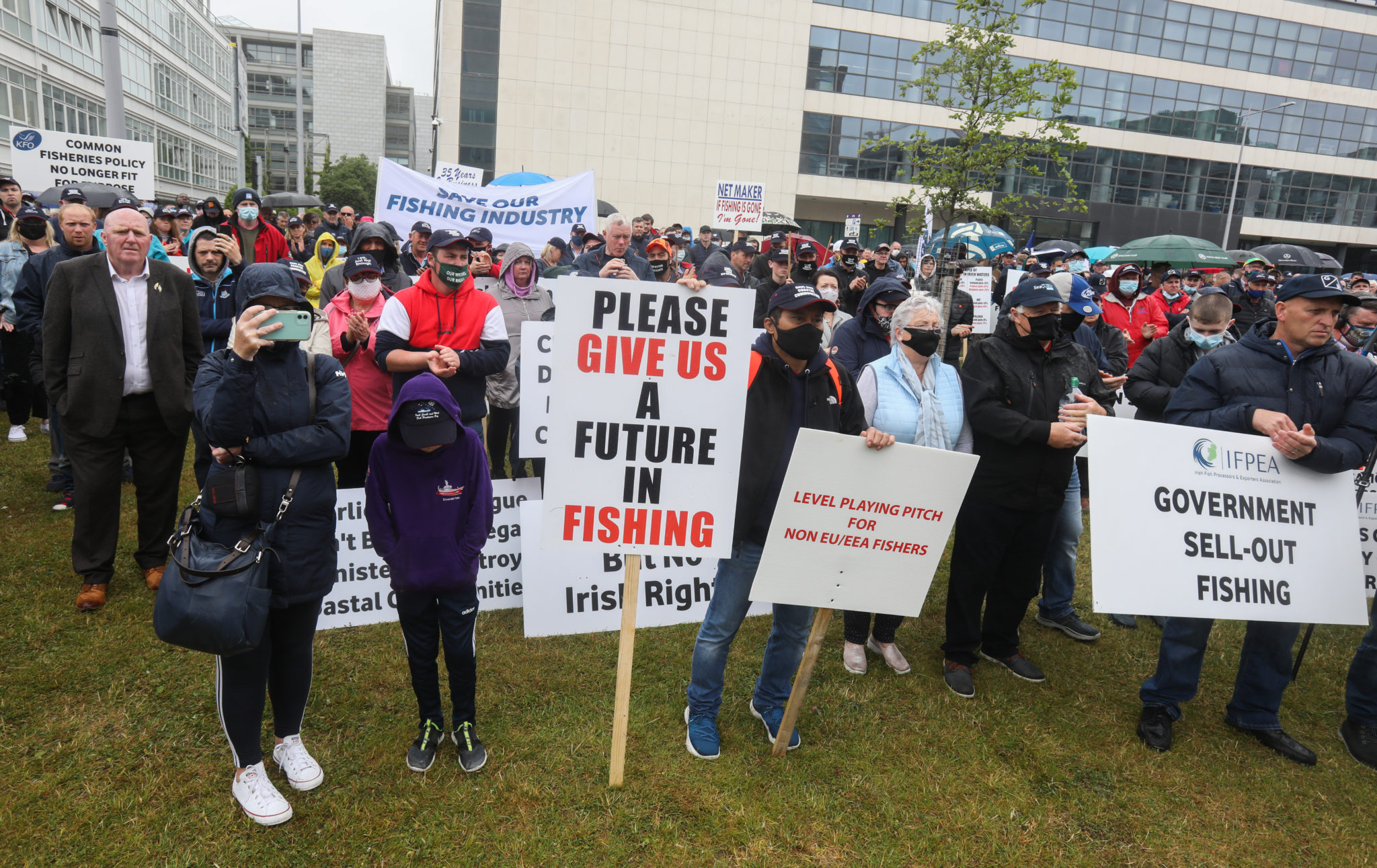 Pictured are fishermen carrying signs and banners as they protest outside a meeting of the Dail in Dublin
