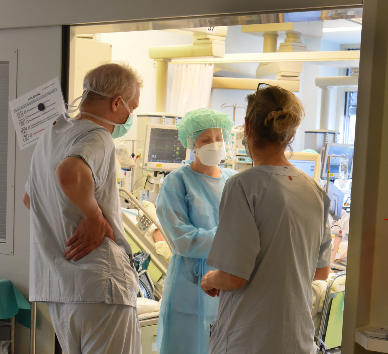 Doctors and nurses talk in the Covid-19 ward of an Intensive Care Unit at Leipzig University Hospital in Germany in April 2021.