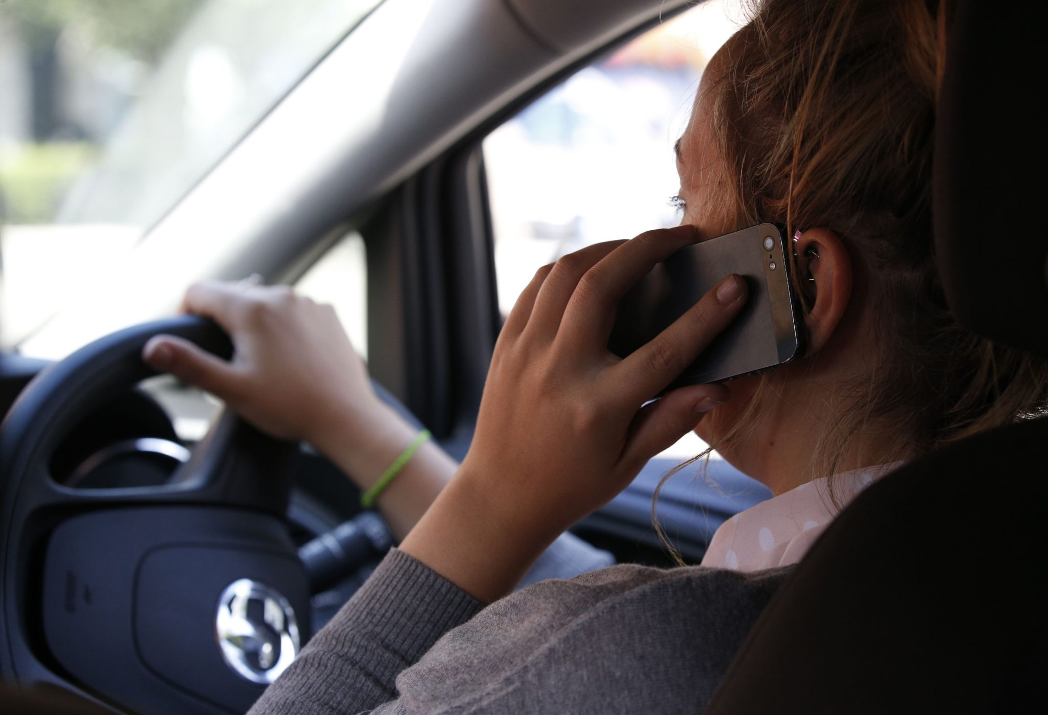 A woman on her mobile phone while driving