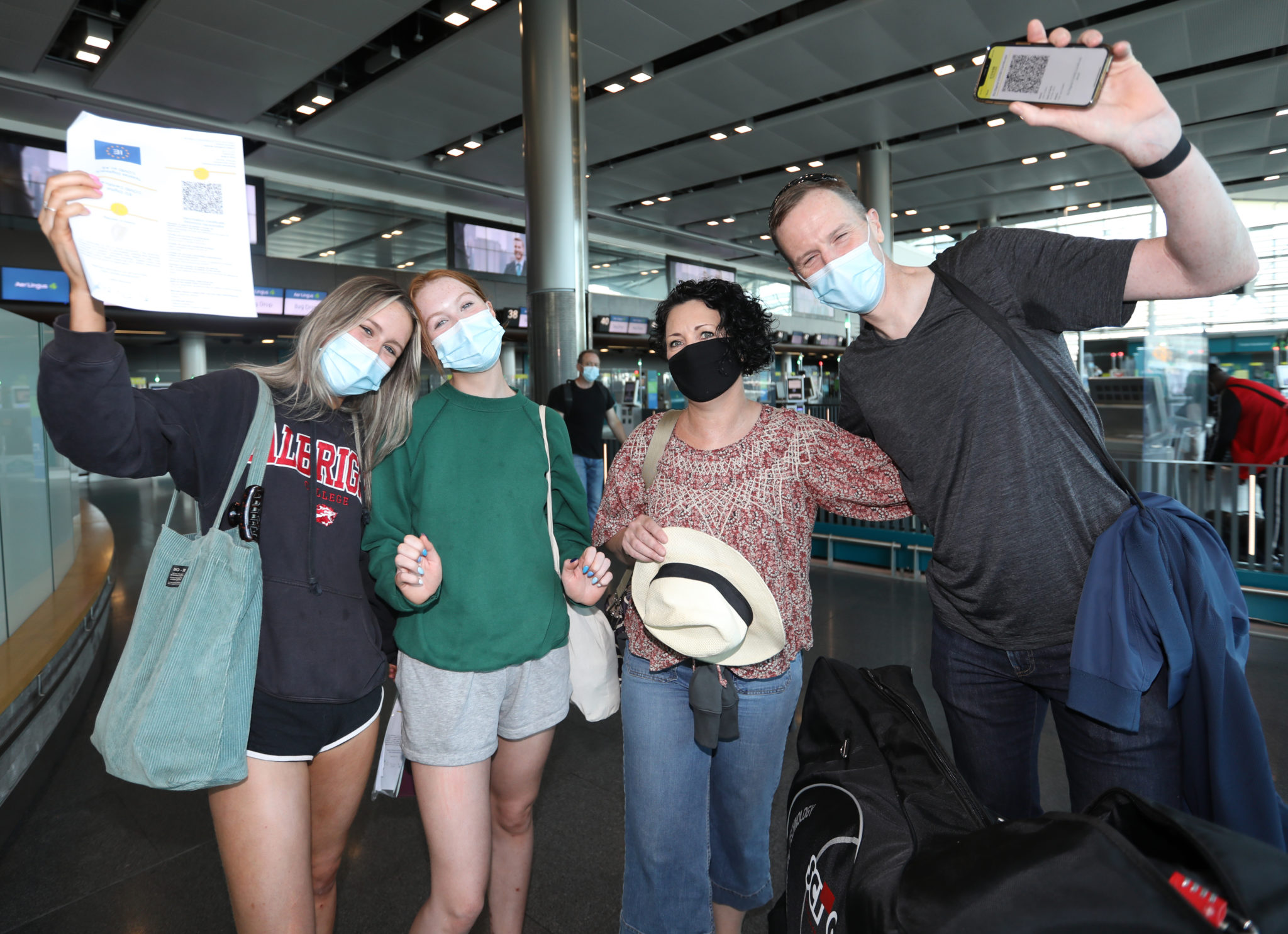 Pictured John Collins, Sandra Whitney, Keelin and Aoibh from Dublin wearing face masks and holding their Covid Vaccine certs in Dublin Airport so they can travel to France
