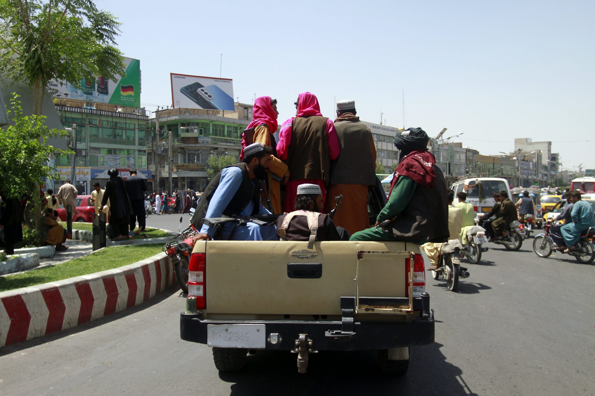 Taliban fighters sit on the back of a vehicle in the city of Herat, west of Kabul, Afghanistan, 14-08-2021. Image: Hamed Sarfarazi/AP/Press Association Images