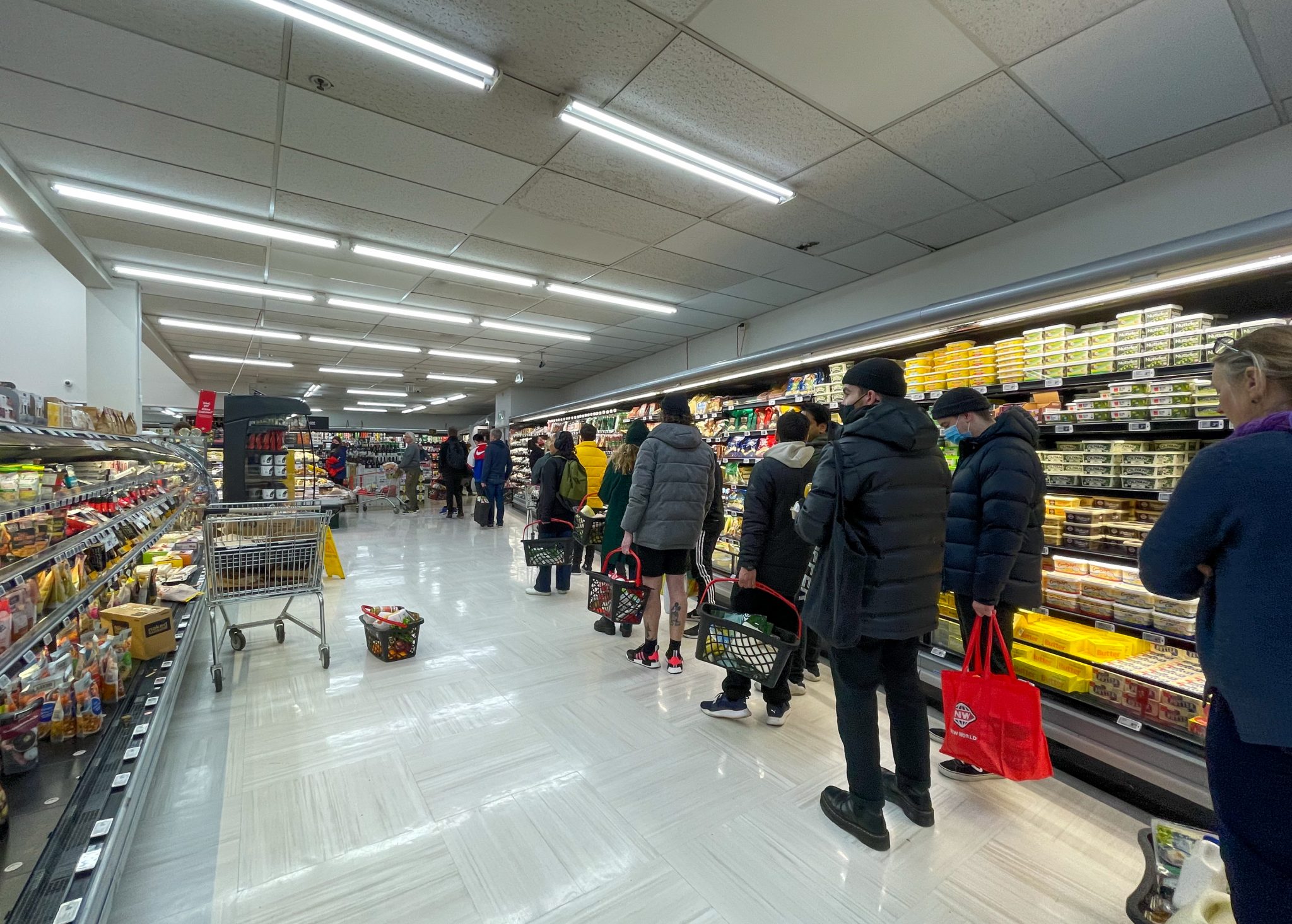 People buy food and daily necessities at a supermarket to prepare for a national COVID-19 lockdown in Wellington, New Zealand