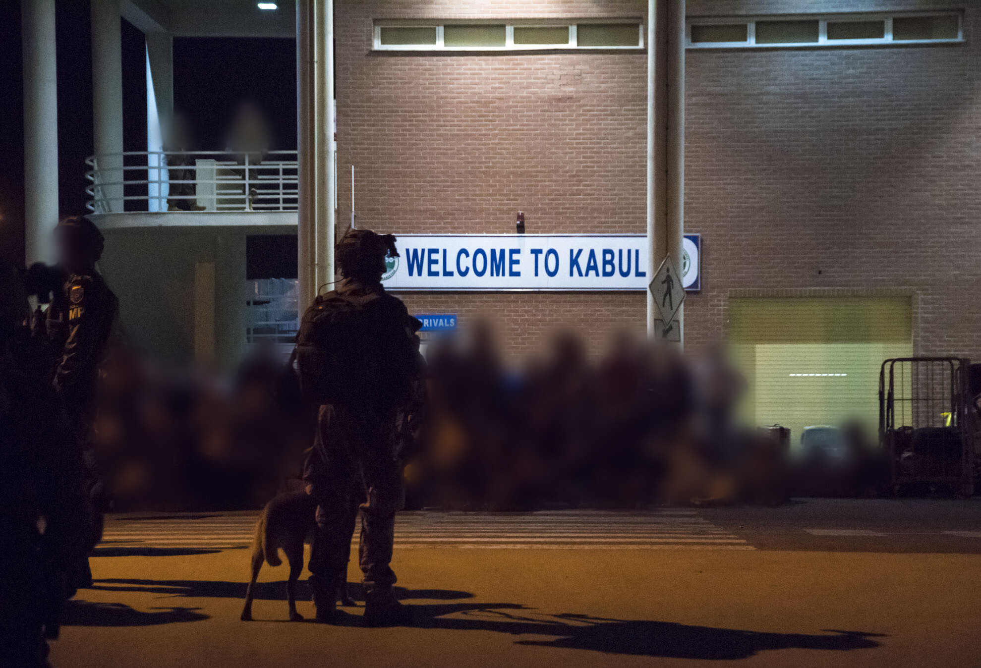 Handout photo taken and released by the French Etat-major des Armees on August 17th, 2021 shows special forces secure the area while French and Afghan nationals board a military transport plane at Kabul Airport.