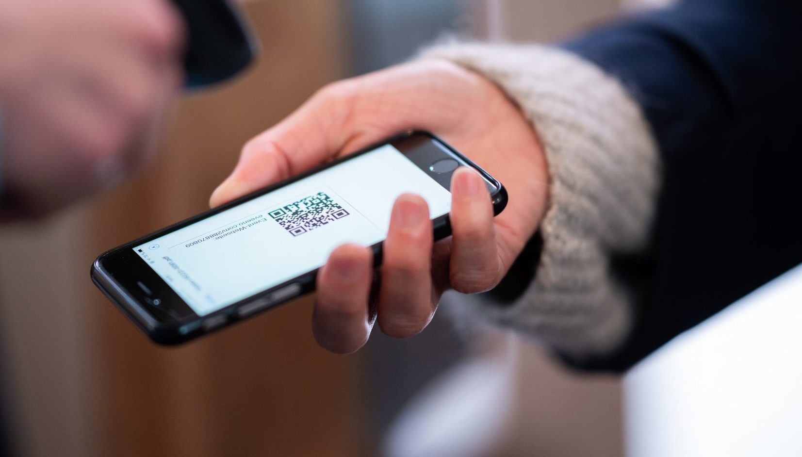 A woman has a QR code scanned on her smartphone in Germany in April 2021
