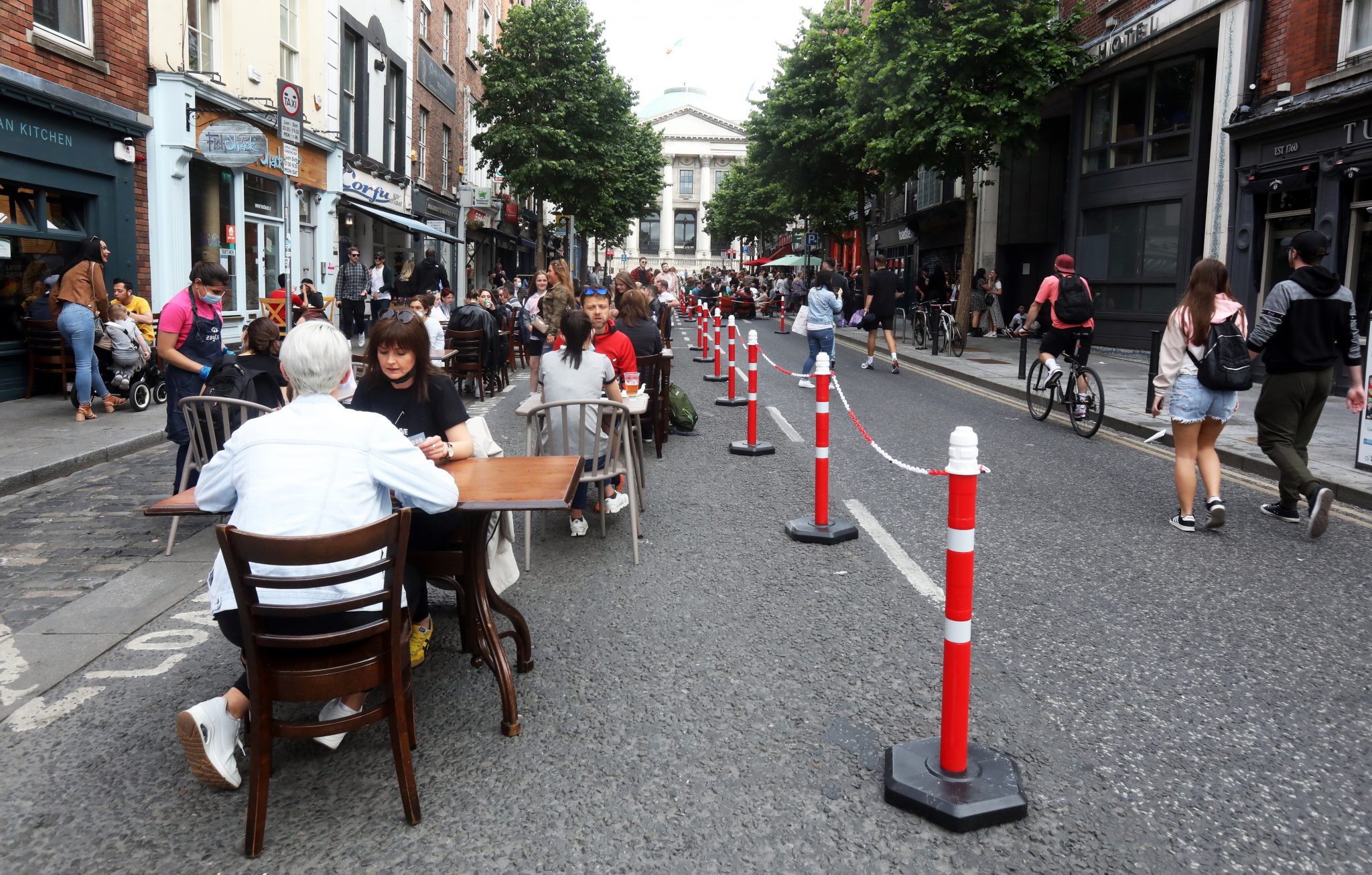 People enjoy food and drink on Parliament Street on the first Saturday of outdoor dining