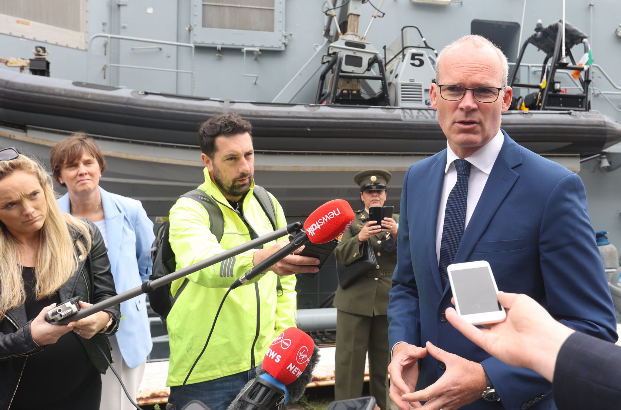 Foreign Affairs Minister Simon Coveney speaks to the media after disembarking the L.É. Samuel Beckett on Sir John Rogerson's Quay