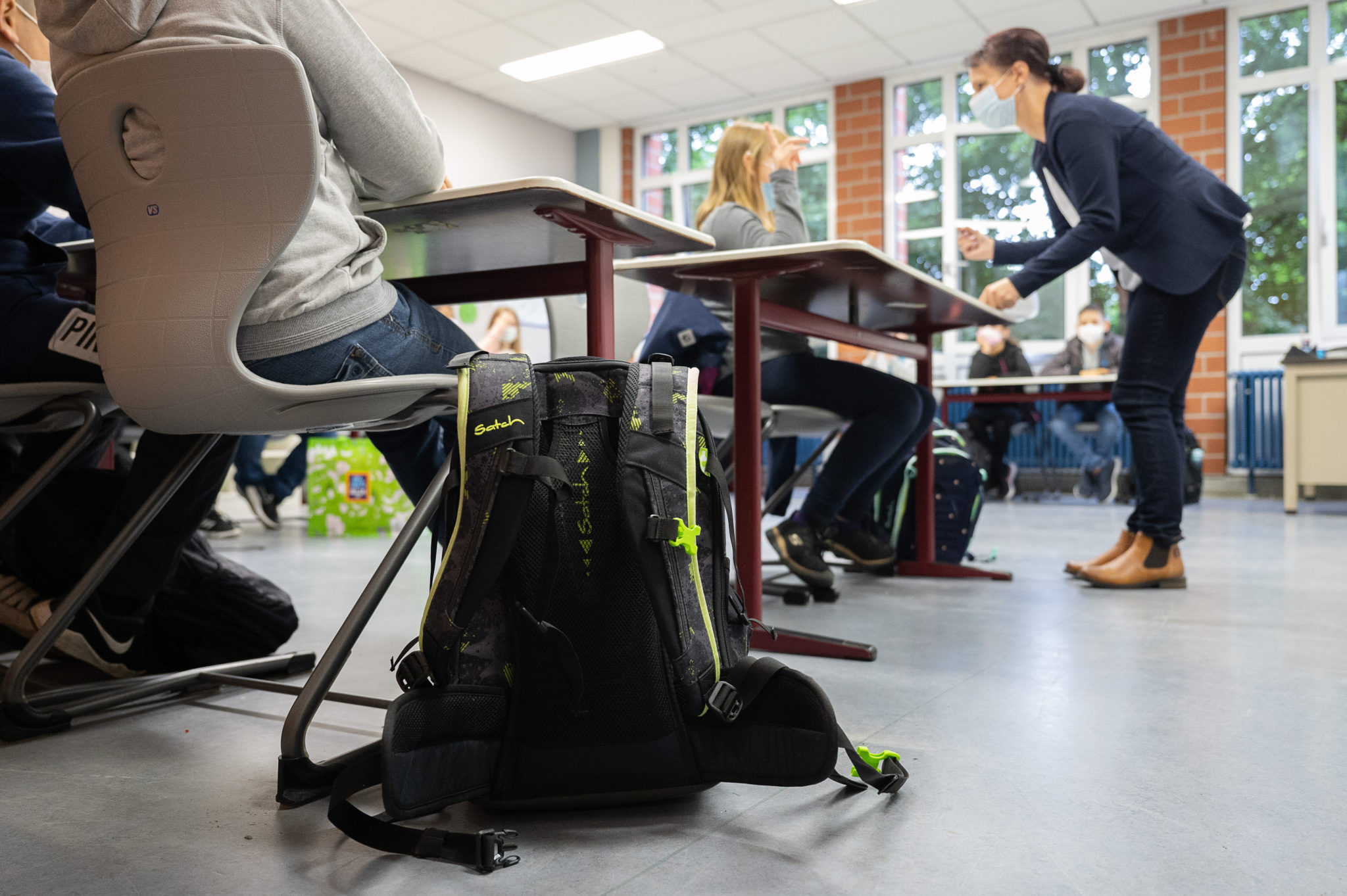 A backpack stands next to a student's chair in a classroom during the enrollment of a fifth grade class in Germany in August 2021