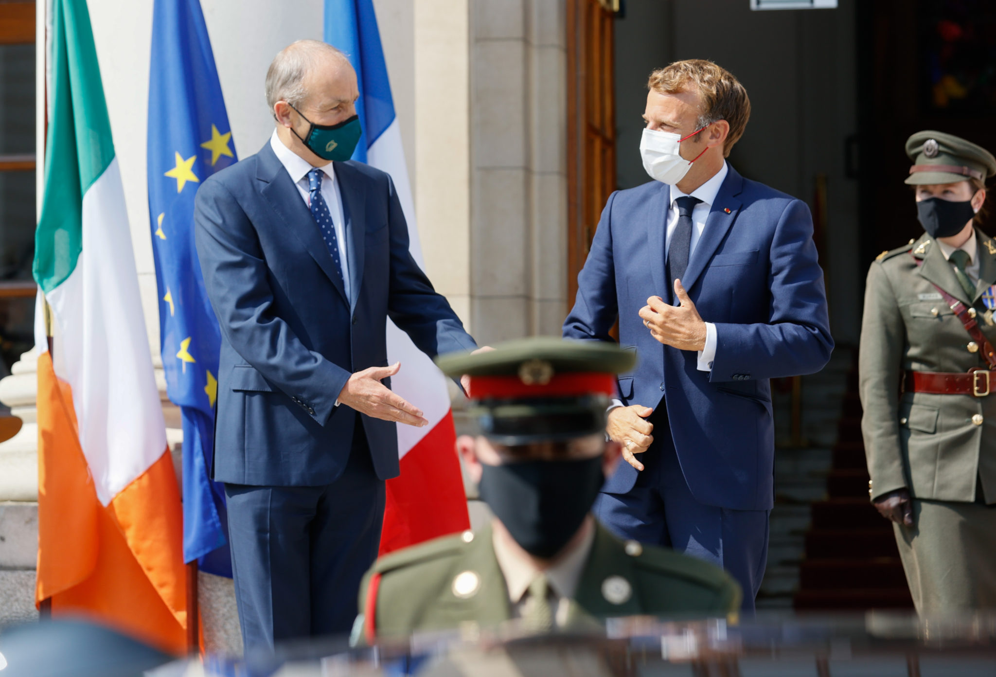 Handout photo of Taoiseach Micheal Martin (left) greeting French President Emmanuel Macron at Government Buildings in Dublin on August 26th, 2021.