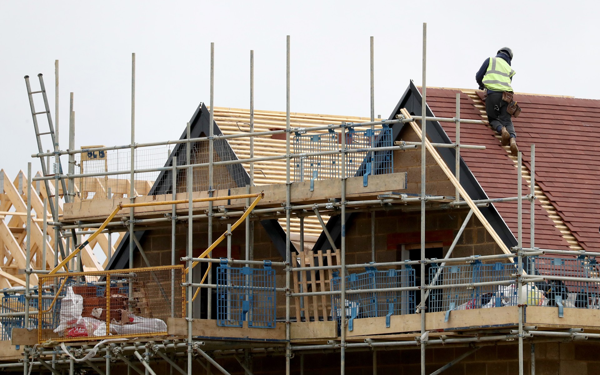 Builder working on the roof of a new house