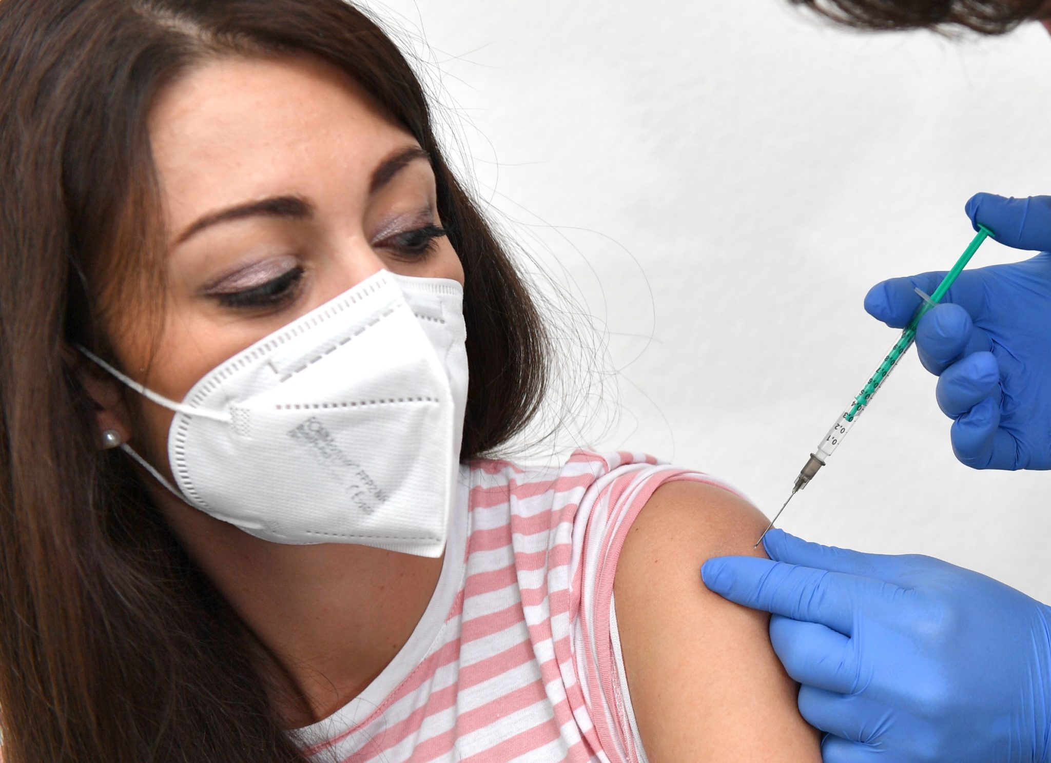 A young woman being vaccinated