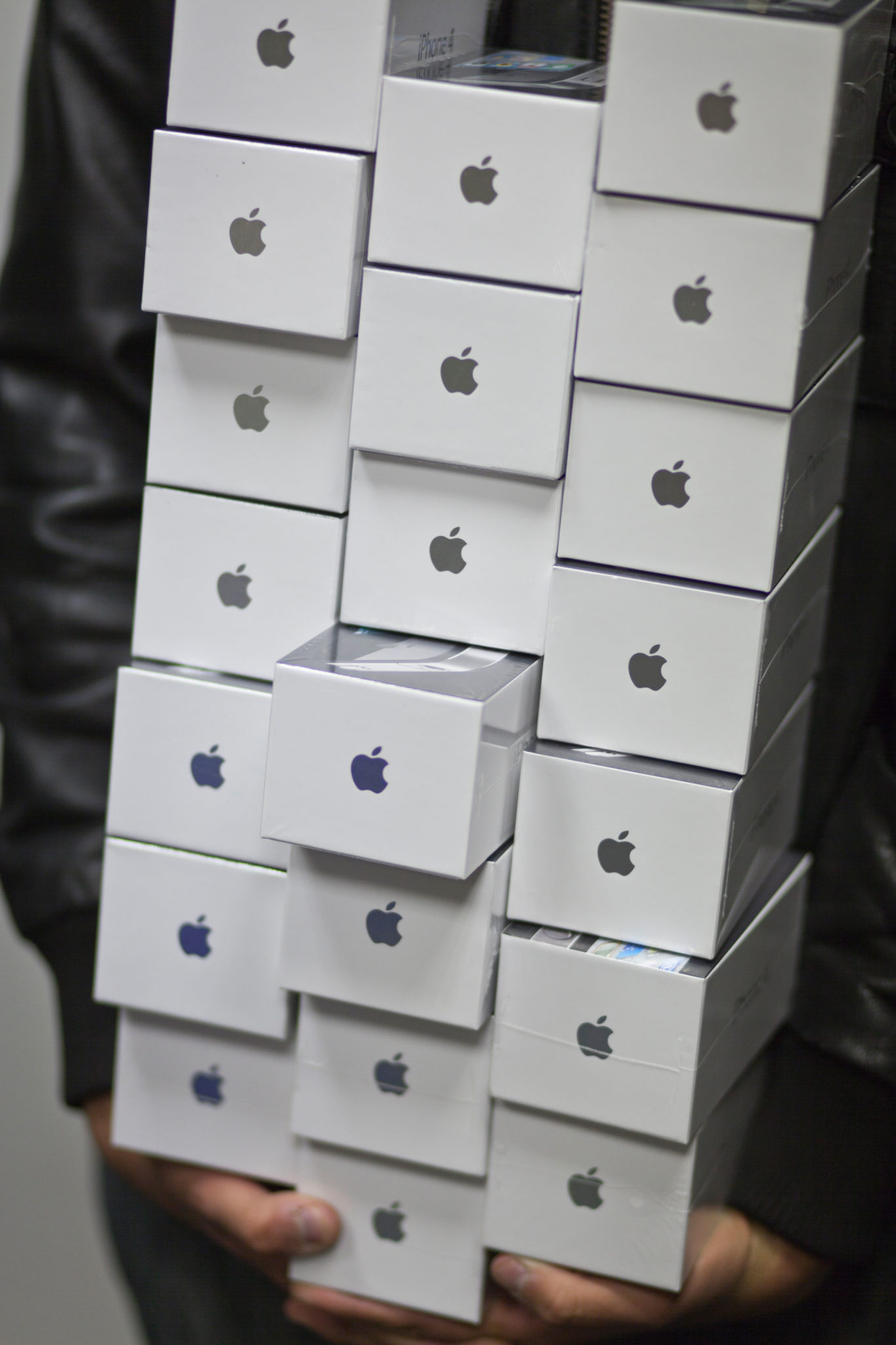 A person carries boxes of Apple iPhones in August 2010. 