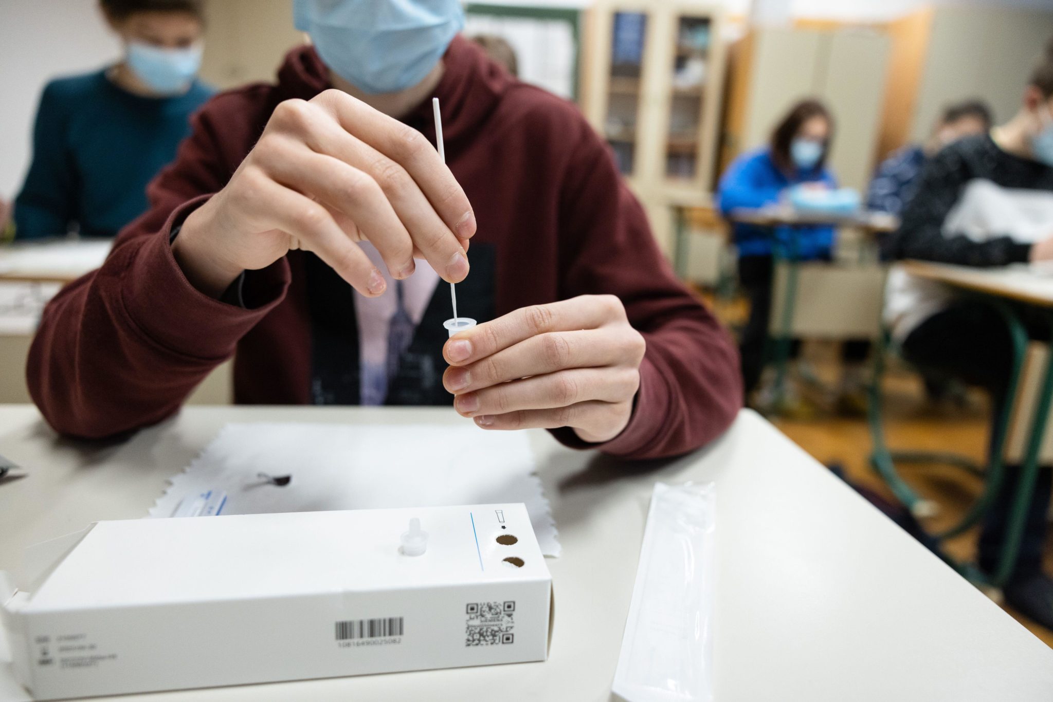 A student self-tests with a rapid COVID-19 antigen kit at a primary school in Slovenia in November 2021