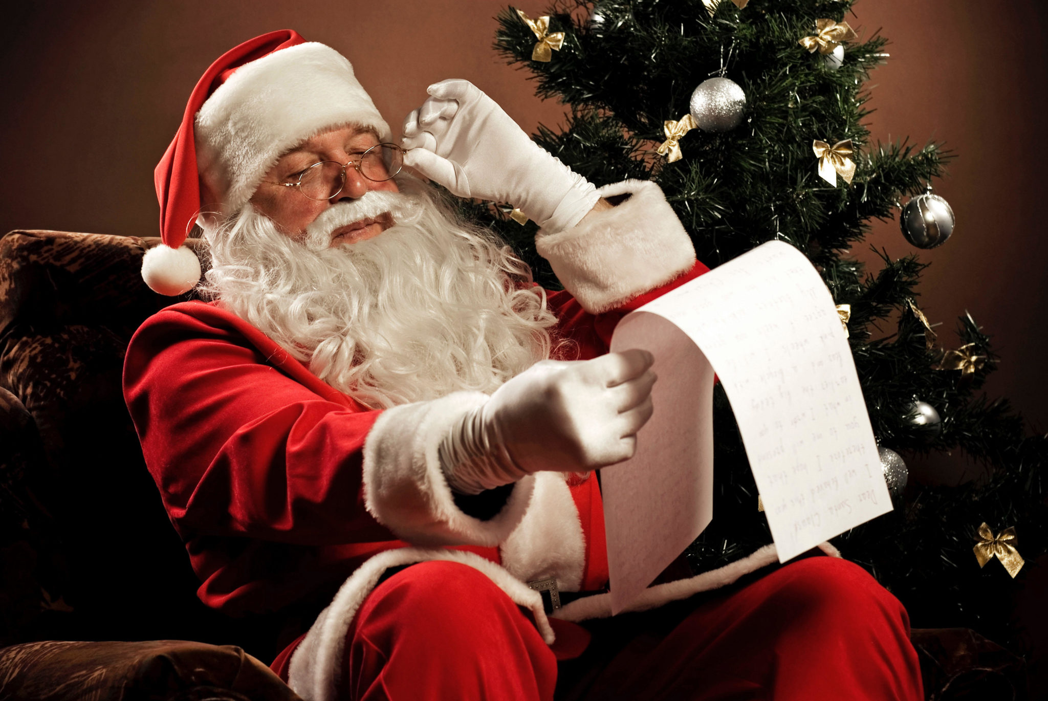 Santa looks at his Christmas list to see who's been naughty or nice.