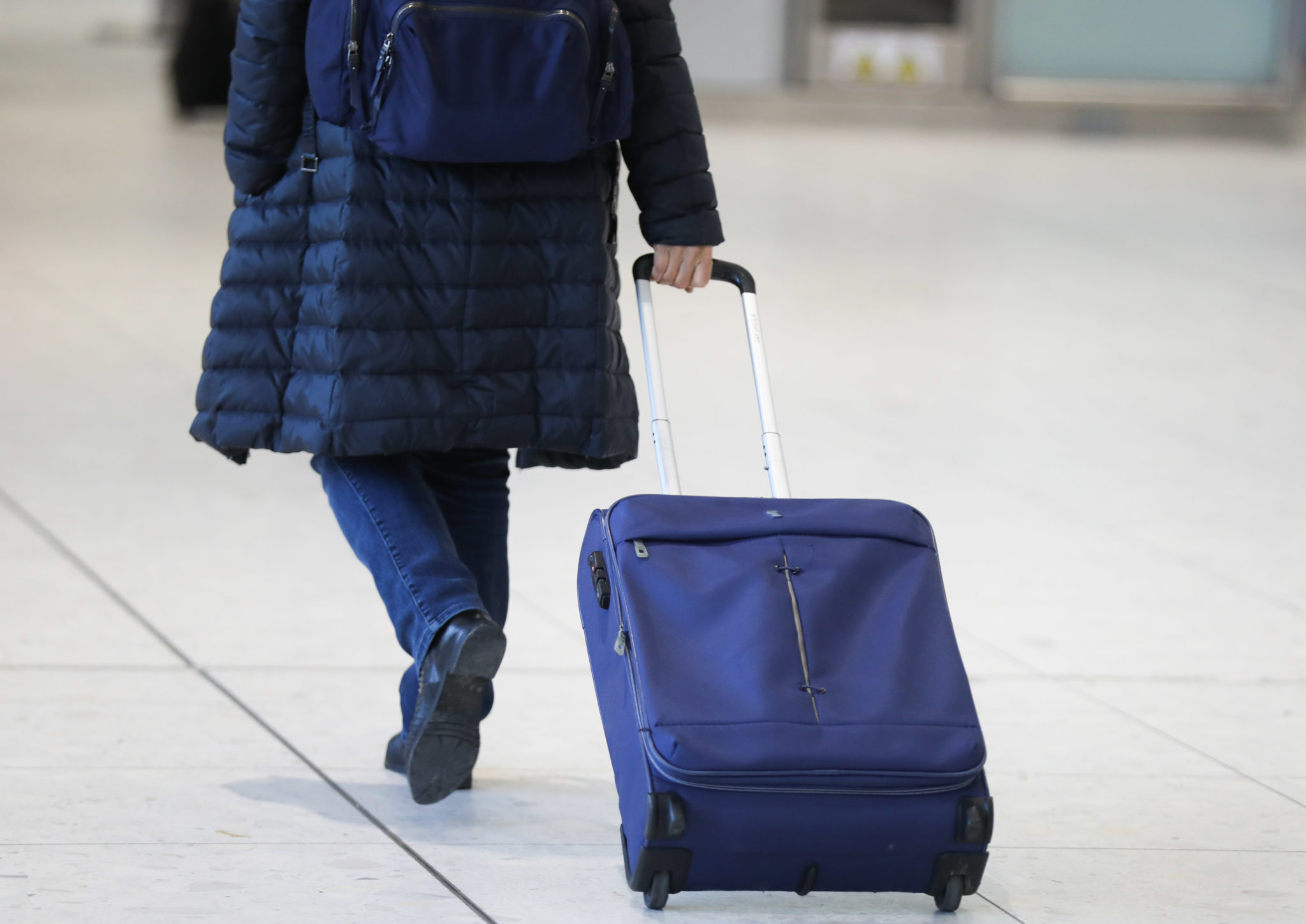 A passenger with a suitcase