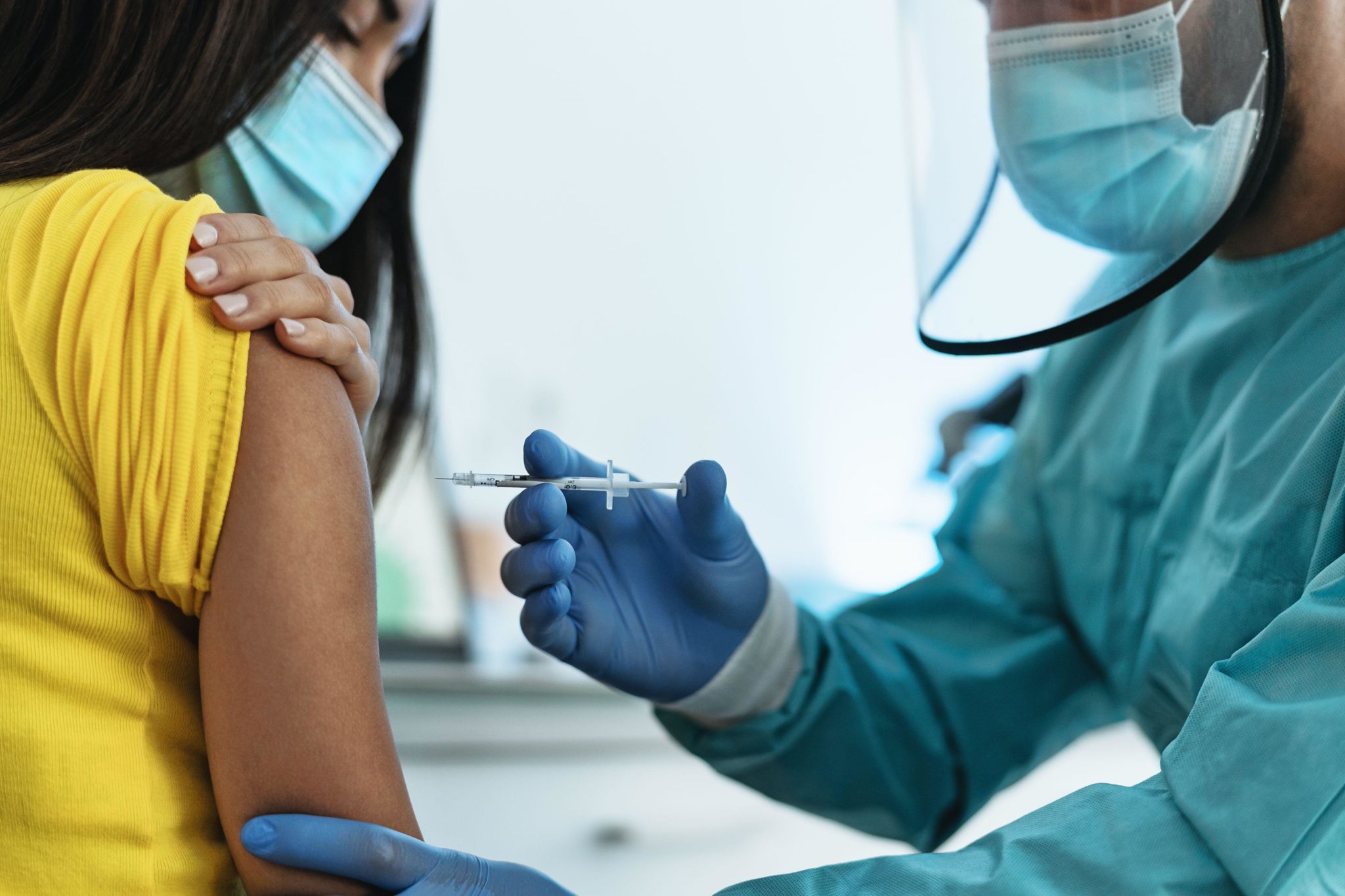 A medical worker giving a vaccine injection to a female patient for preventing coronavirus in Tenerife, Spain in January 2021