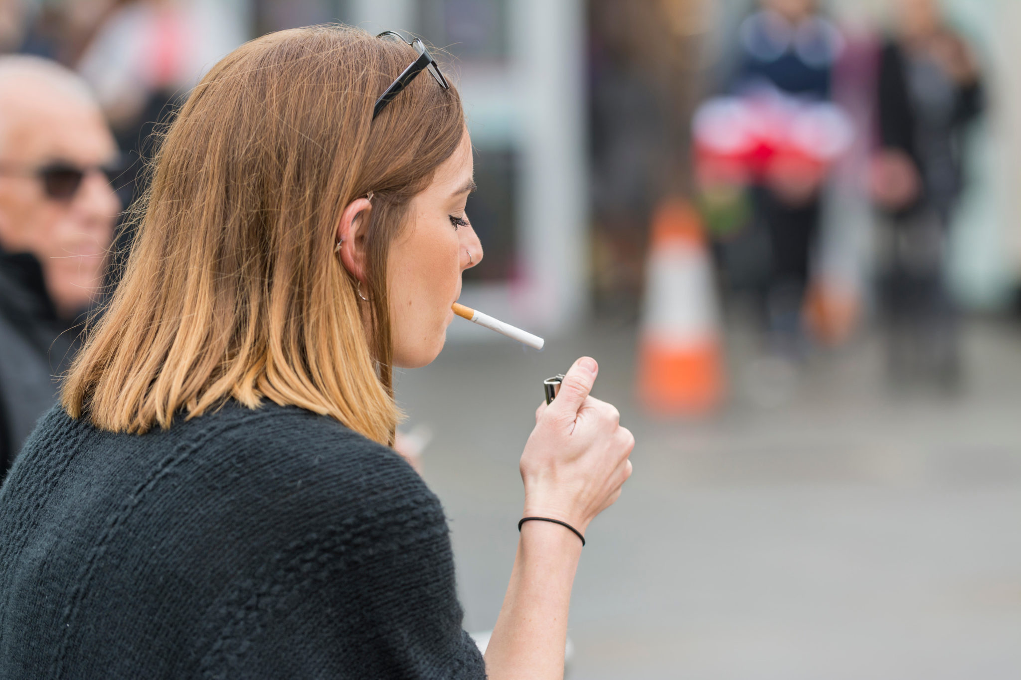 A woman lighting a cigarette in October 2017.