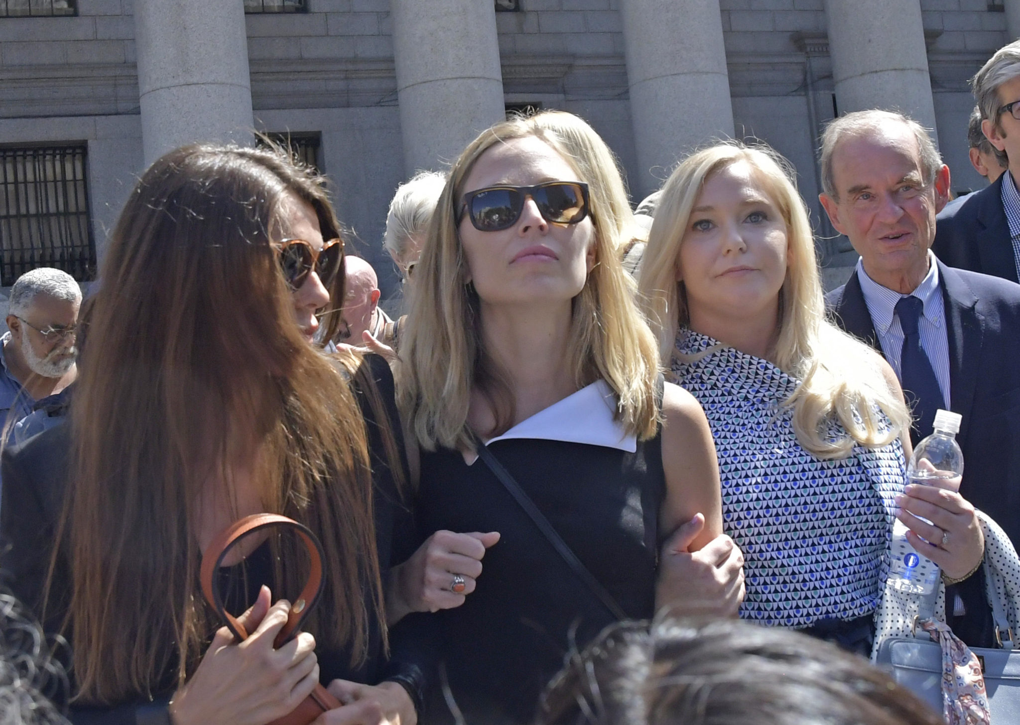 Victims of billionaire Jeffrey Epstein - Annie Farmer, middle, and Virginia Giuffre, right, exit Manhattan Federal Court in August 2019 in New York City.