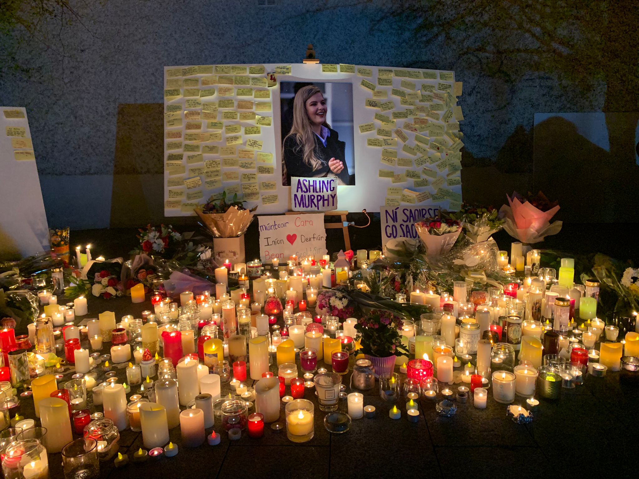 A photo of Ashling Murphy is surrounded by messages and flanked by candles and flowers in Tullamore, Co Offaly.