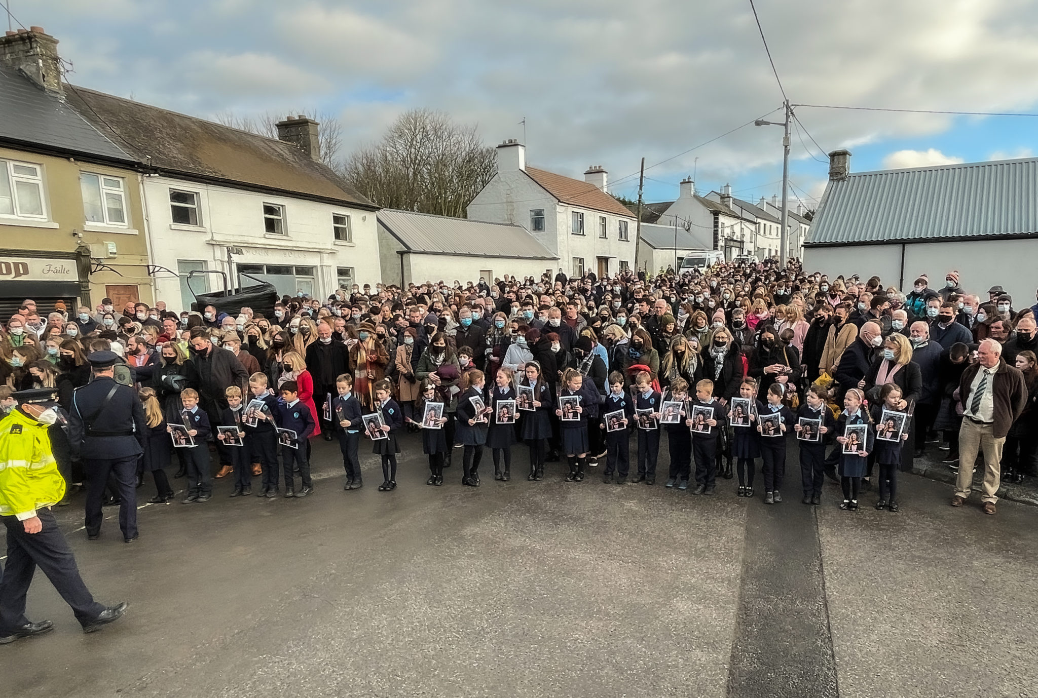 First Class students from Durrow National School outside St. Brigid's Church, Mountbolus, Co. Offaly, holding pictures of their teacher Ashling Murphy