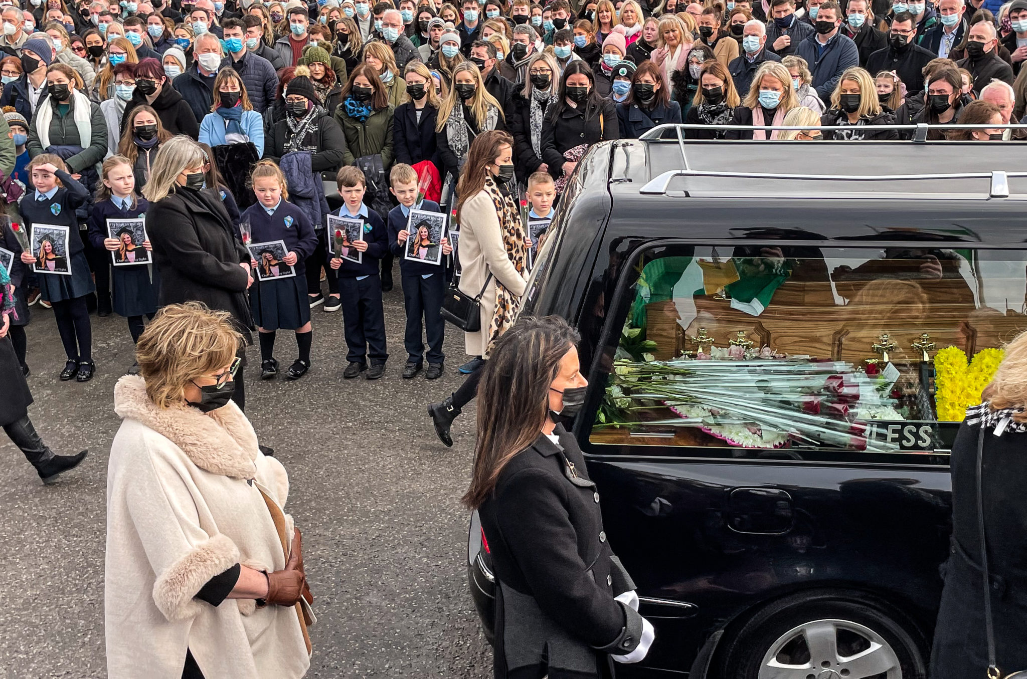 The hearse passing crowds of well-wishers and students from Durrow National School as it arrives outside St Brigid's Church, Mountbolus, Co Offaly, for the funeral of Ashling Murphy