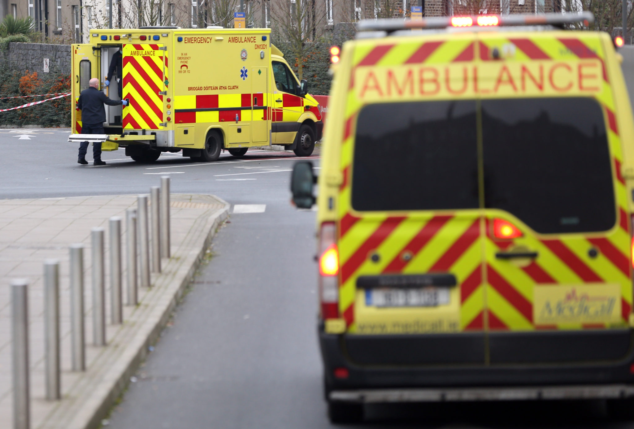 Ambulances with health care workers wearing face masks bring patients into the Mater Hospital in Dublin